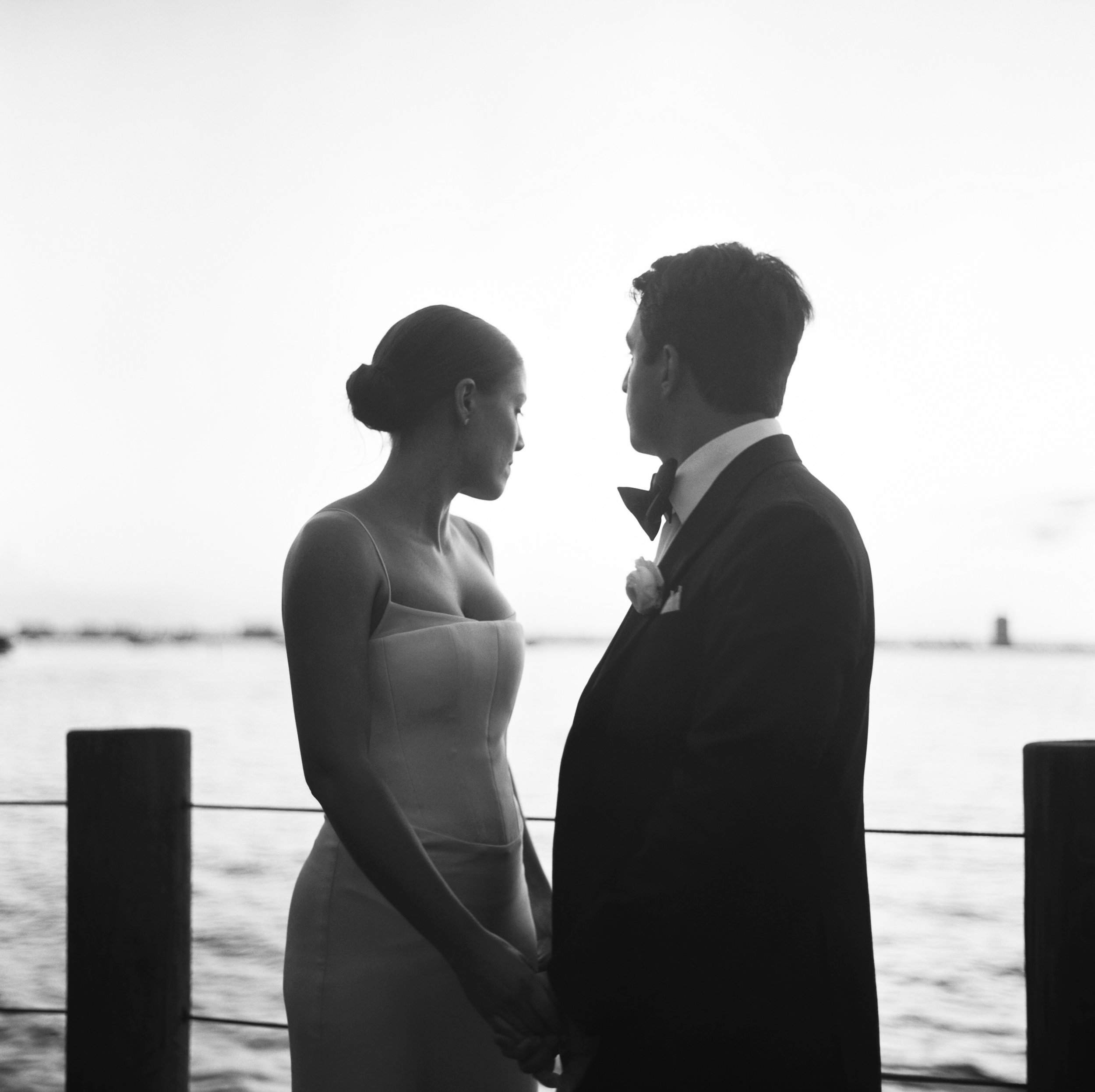 A black and white portrait of a couple looking peaceful and relaxed on their wedding day. Photographed on medium format film by Josie Macbeth.