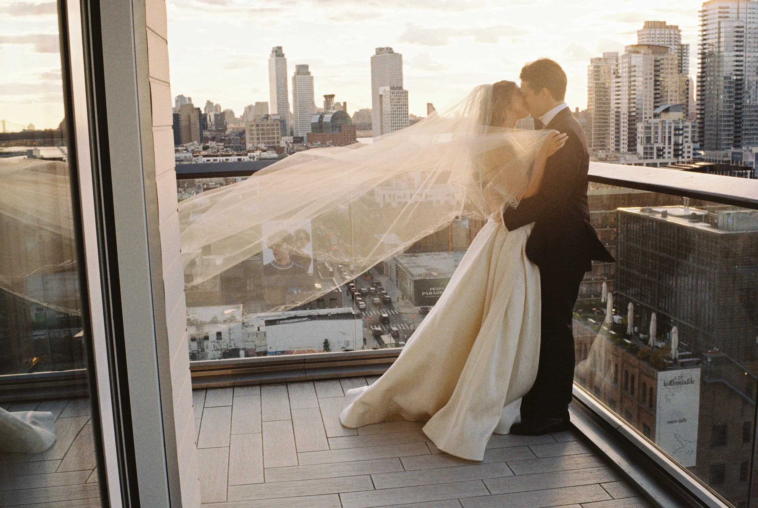 A couple embraces on a rooftop in Brooklyn, New York. Photographed on 35mm film by Josie Macbeth.