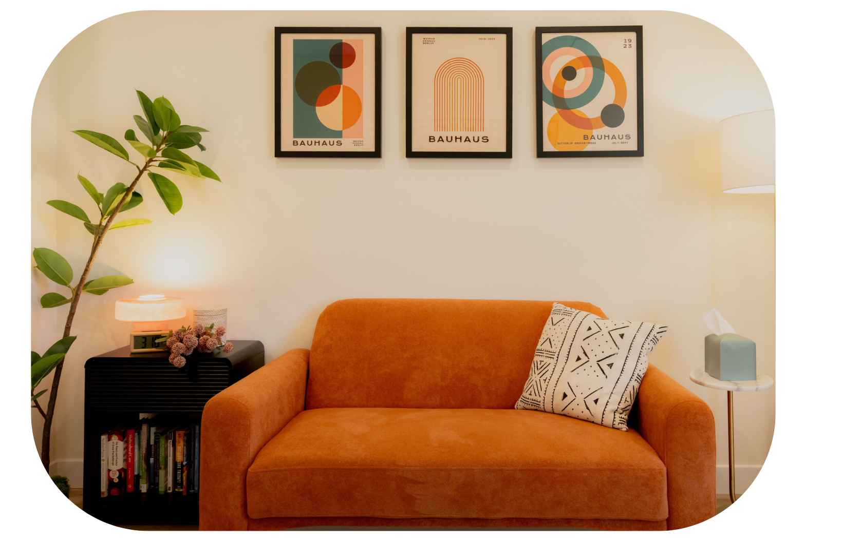 Therapy office couch with three Bauhaus-style prints on the wall above it