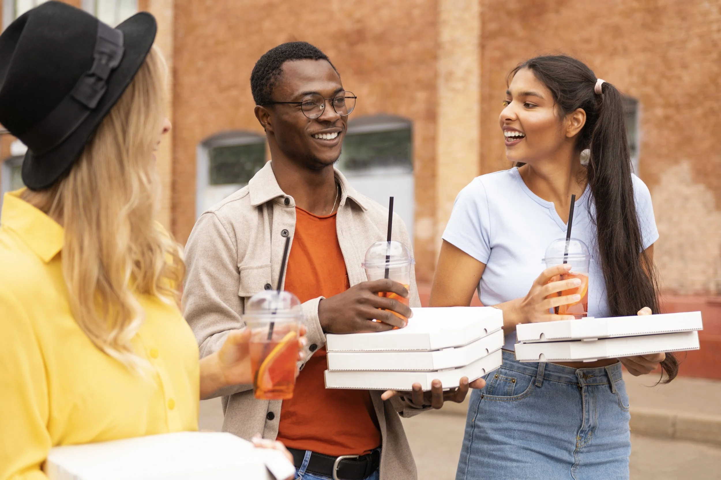 medium-shot-friends-with-pizza-outside.jpg