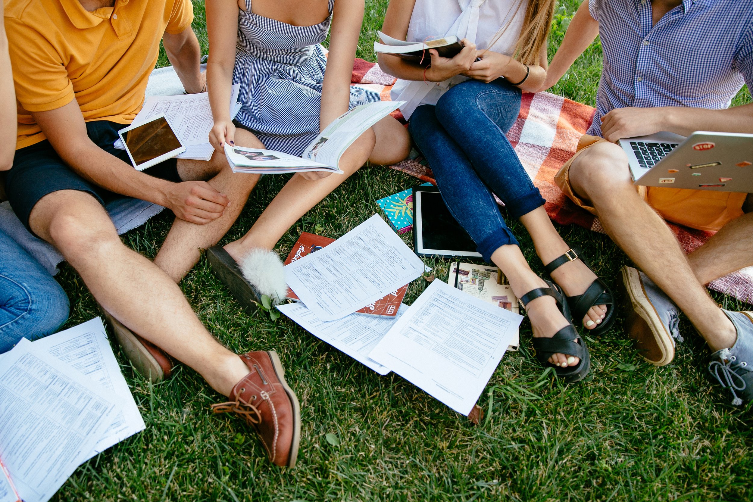 group-students-with-books-tablet-are-studying-outdoors-together-sitting-grass.jpg