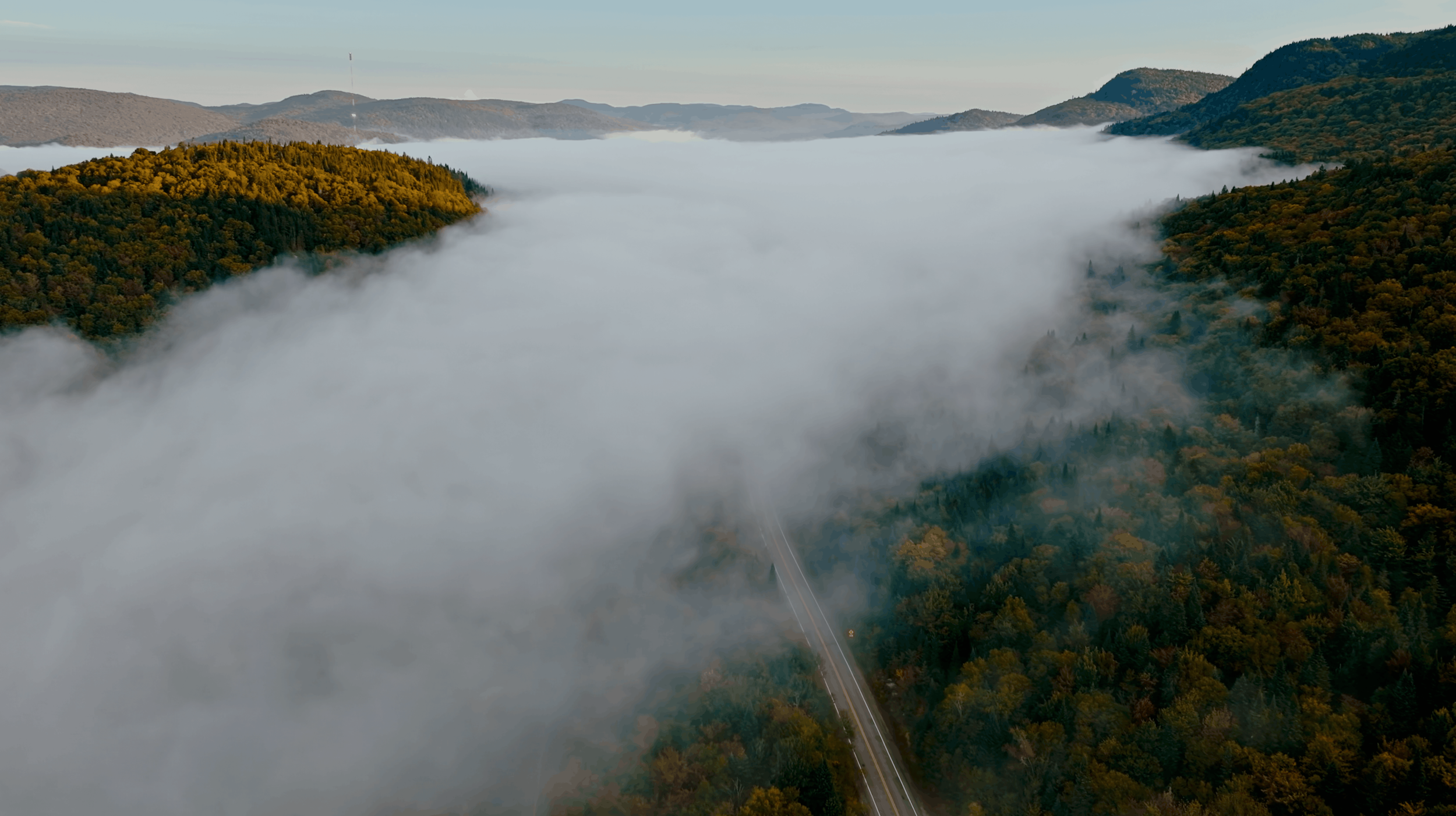 Plan drone au-dessus d'une mer de nuages dans les montagnes au lever du soleil, production aérienne LensBrothers