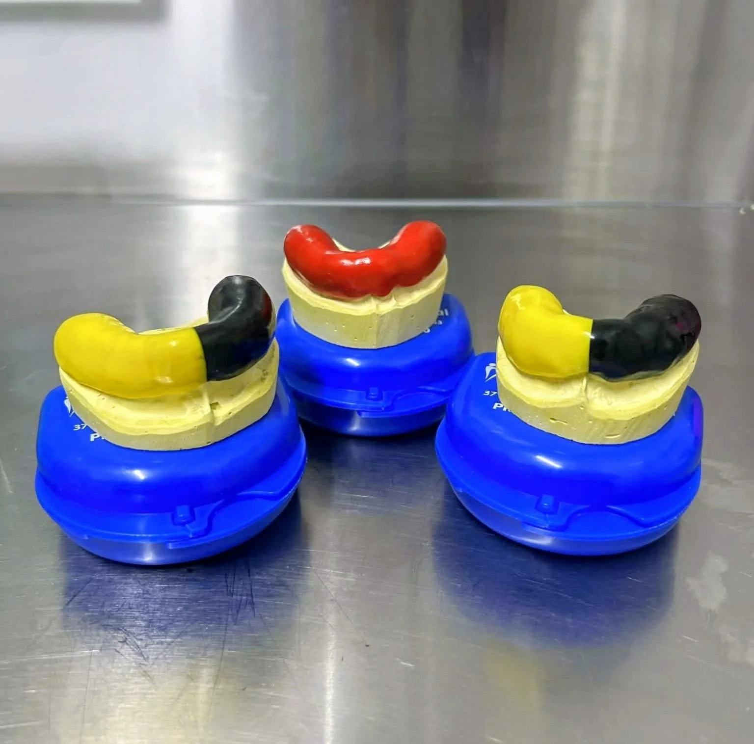 Mouthguards on stainless steel bench.