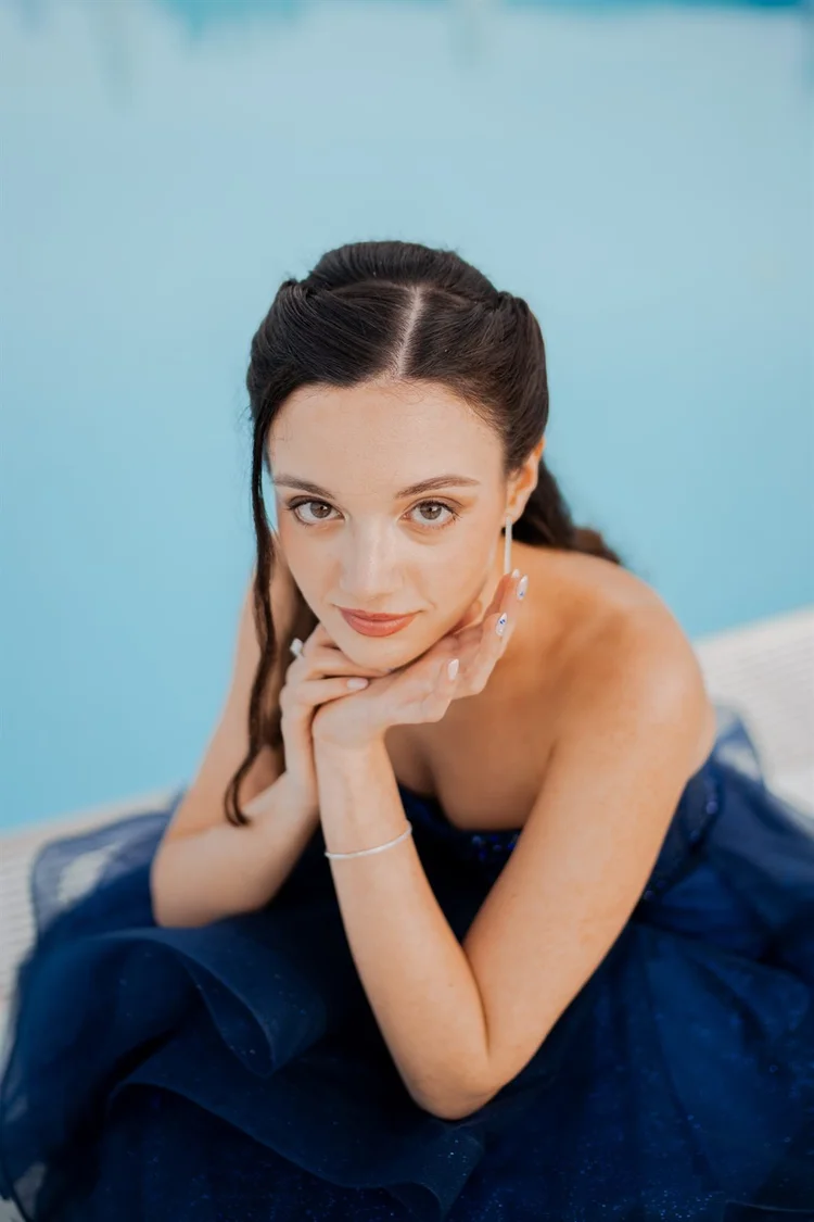 Diciottesimo: ritratto in abito blu con le mani sotto il mento, foto di Matilde Rindi, fotografa a Prato