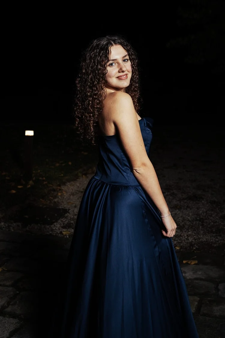 Diciottesimo: ragazza riccia in abito blu, foto notturna, foto di Matilde Rindi, fotografa a Prato