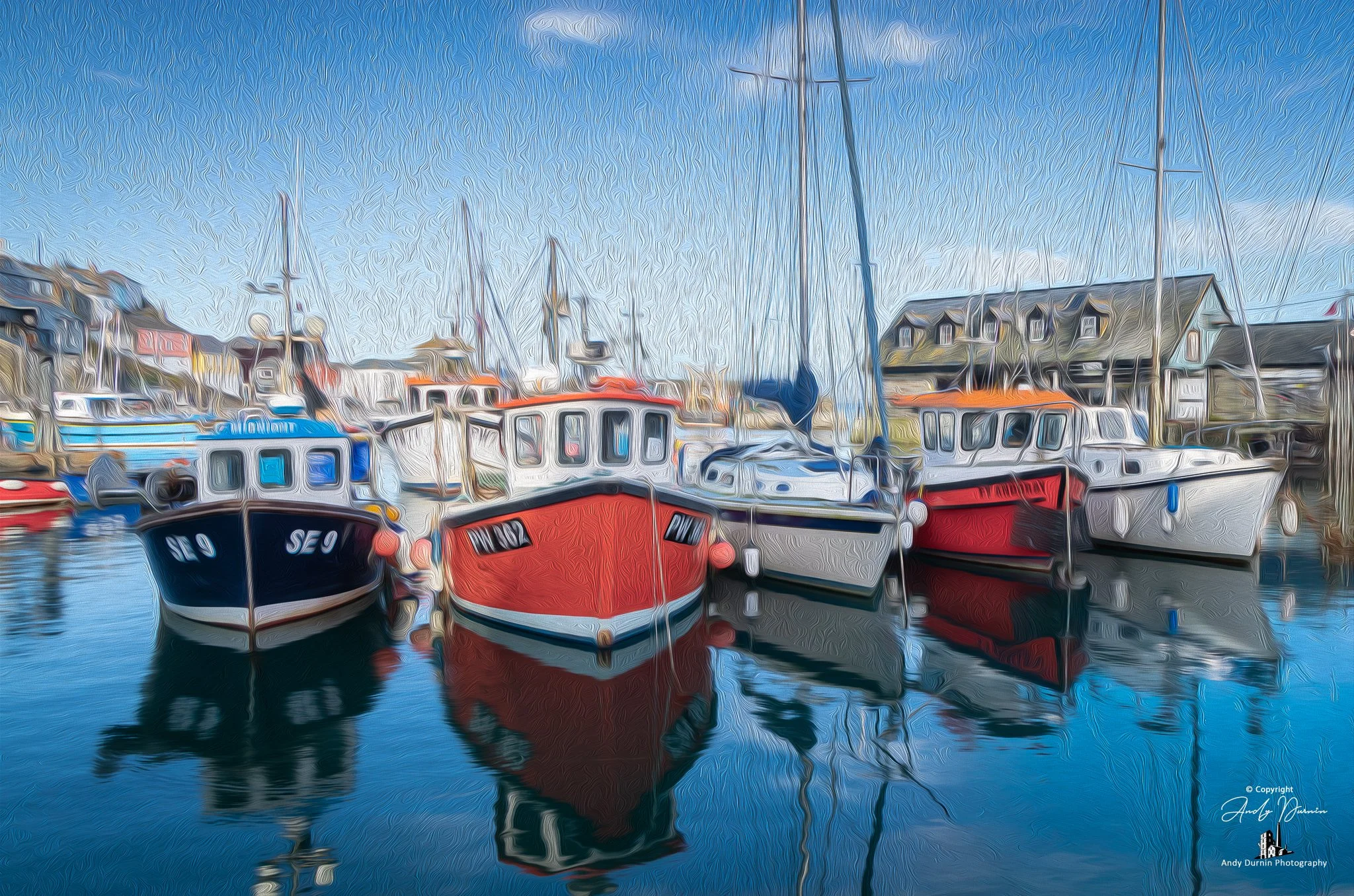 A painterly-style image of colourful fishing boats moored in Mevagissey Harbour on a clear blue day, with vivid reflections in the calm water and soft textured details throughout.