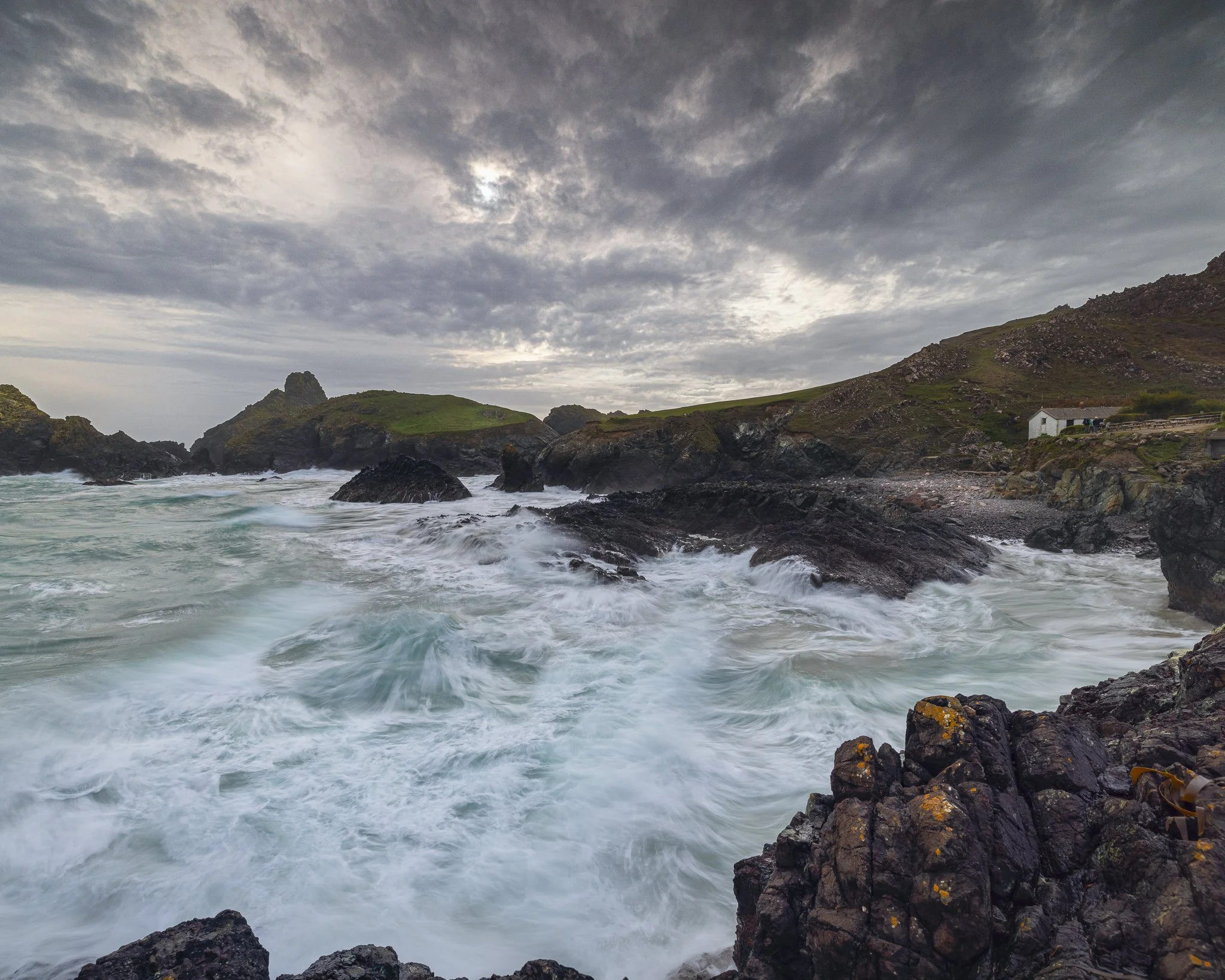Choppy seas rolling into Kynance Cove in Cornwall, captured as dramatic coastal photography wall art.