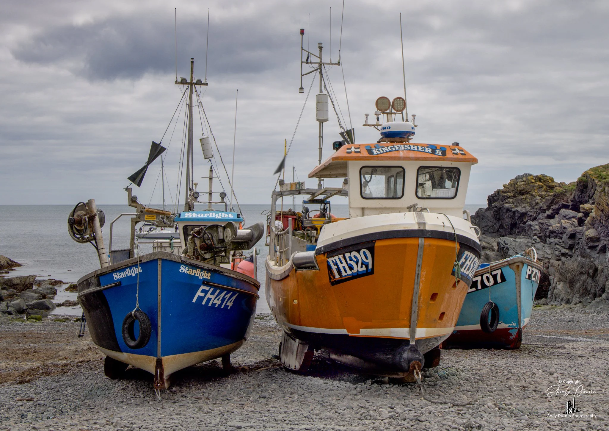 Colour fine-art photography of fishing boats at Cadgwith Cove, Cornwall — a classic Cornish village scene with traditional boats, harbour textures and coastal charm