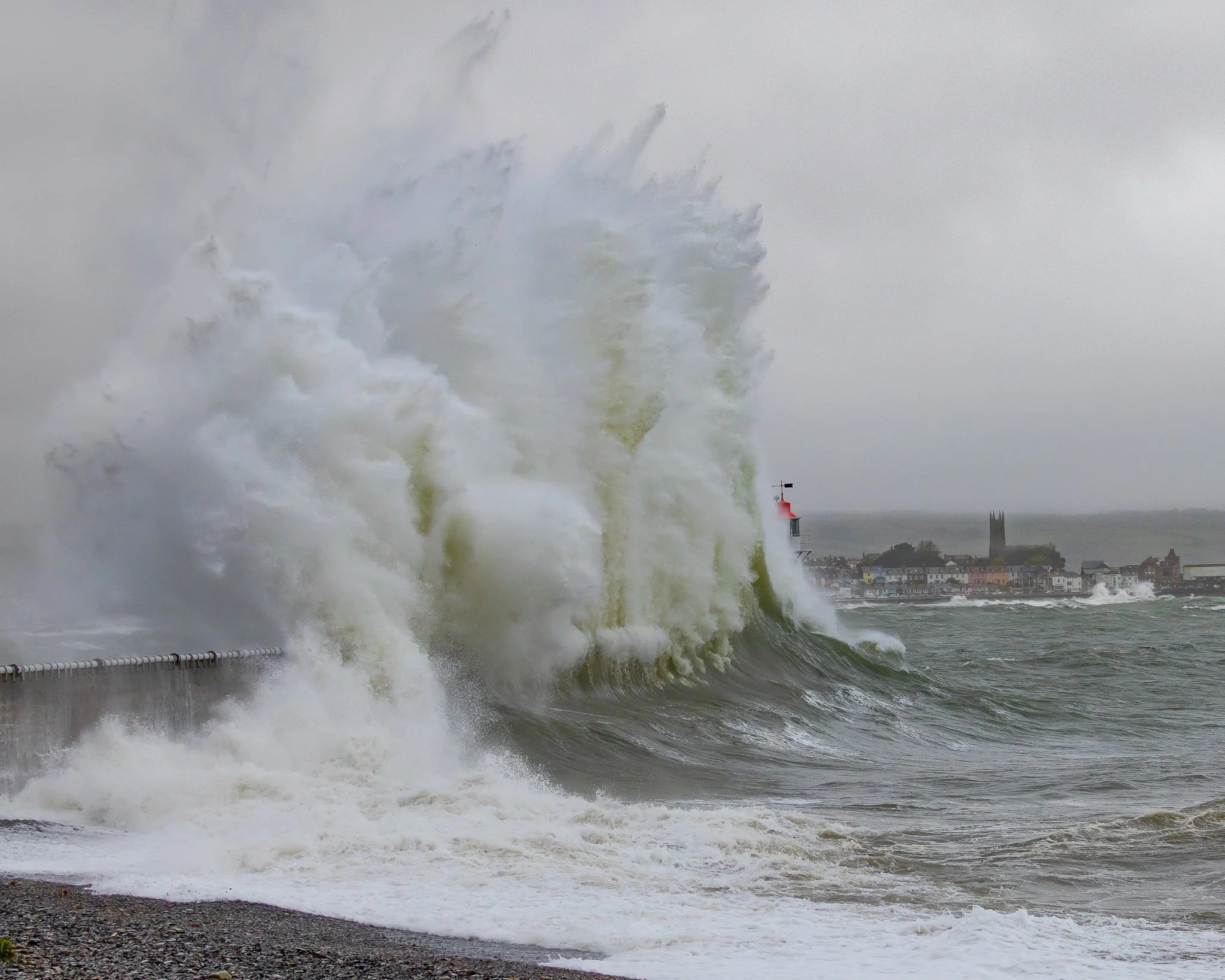 Storm waves crashing at Newlyn Harbour in Penwith, Cornwall, captured as a dramatic coastal fine art photography print.