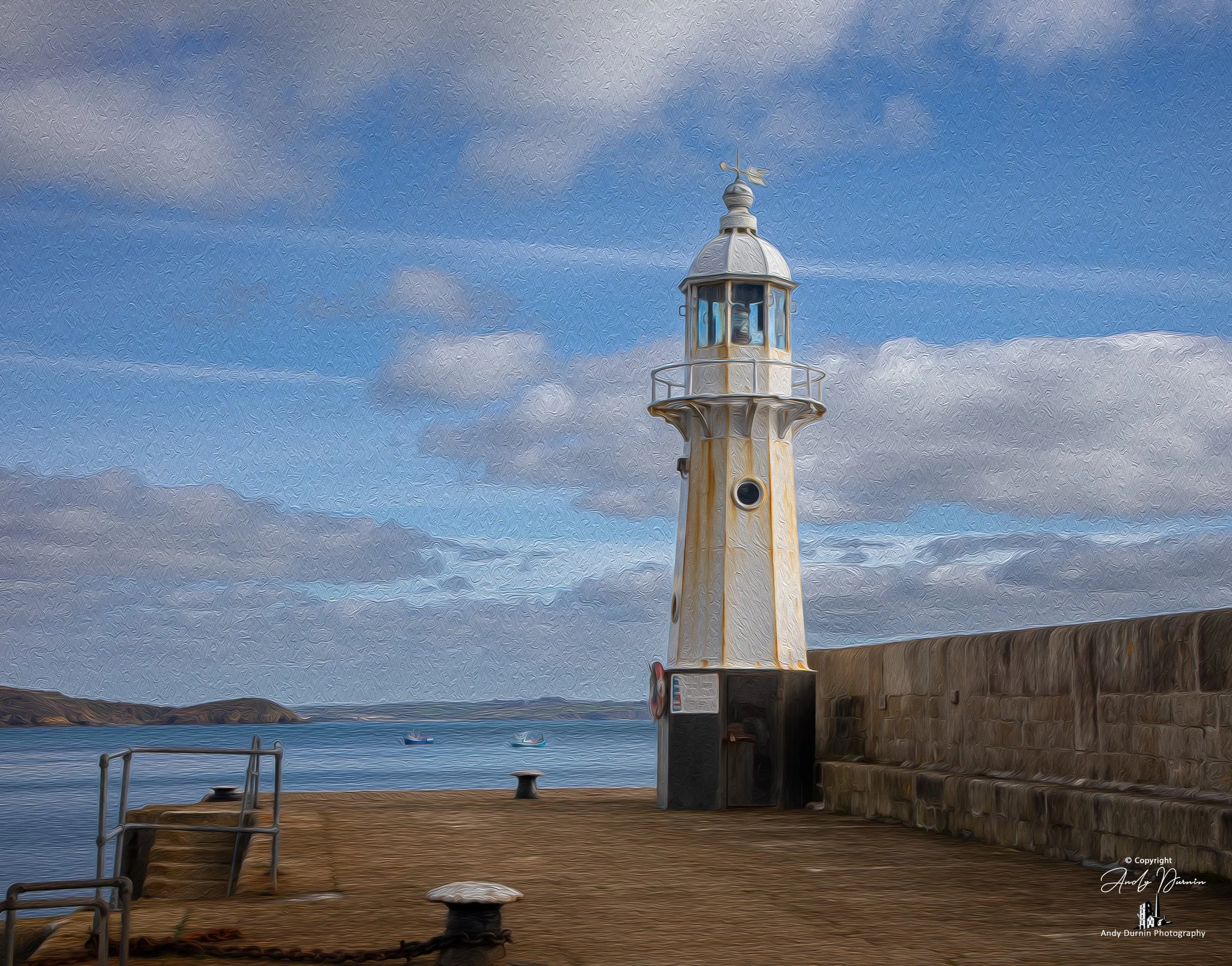 A painterly-style image of Mevagissey Lighthouse standing on the harbour wall, with soft textured clouds and calm blue coastal waters stretching out behind it.