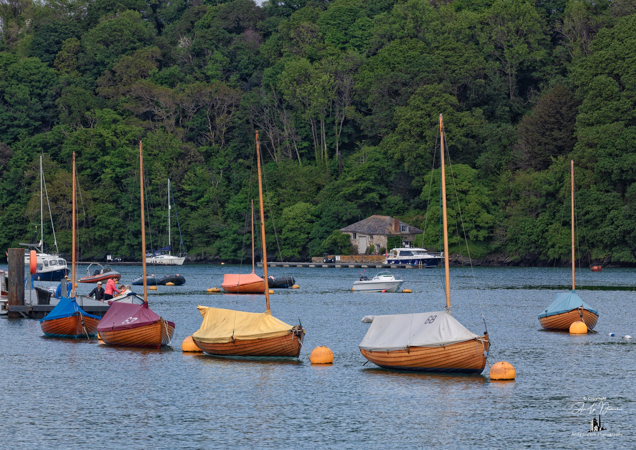 Close-up River Fowey mooring scene with traditional wooden boats and rich woodland tones—classic Cornwall boating photography with strong texture and detail.