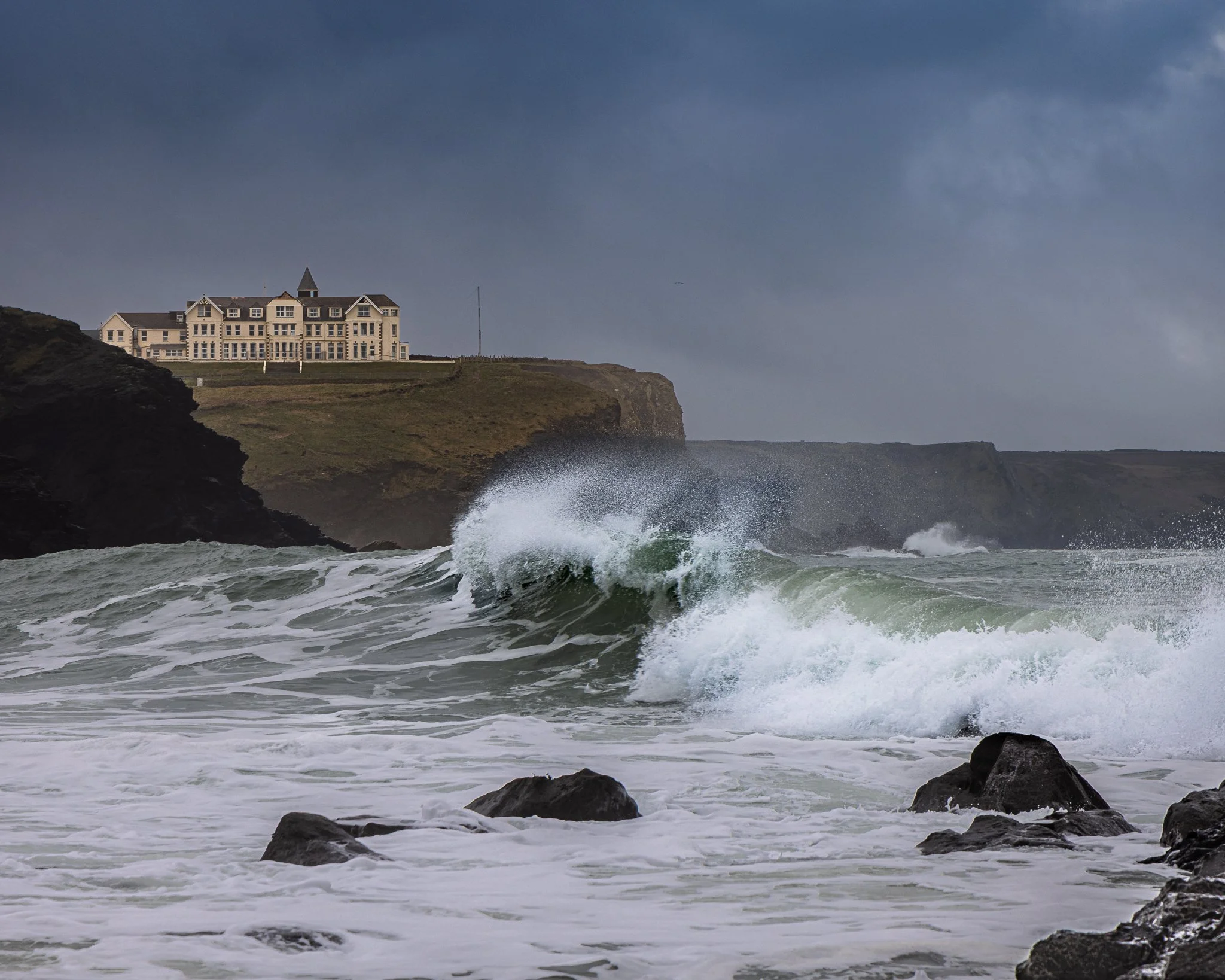Stormy seas at Church Cove on The Lizard Peninsula, with waves breaking along the rugged Cornish coast