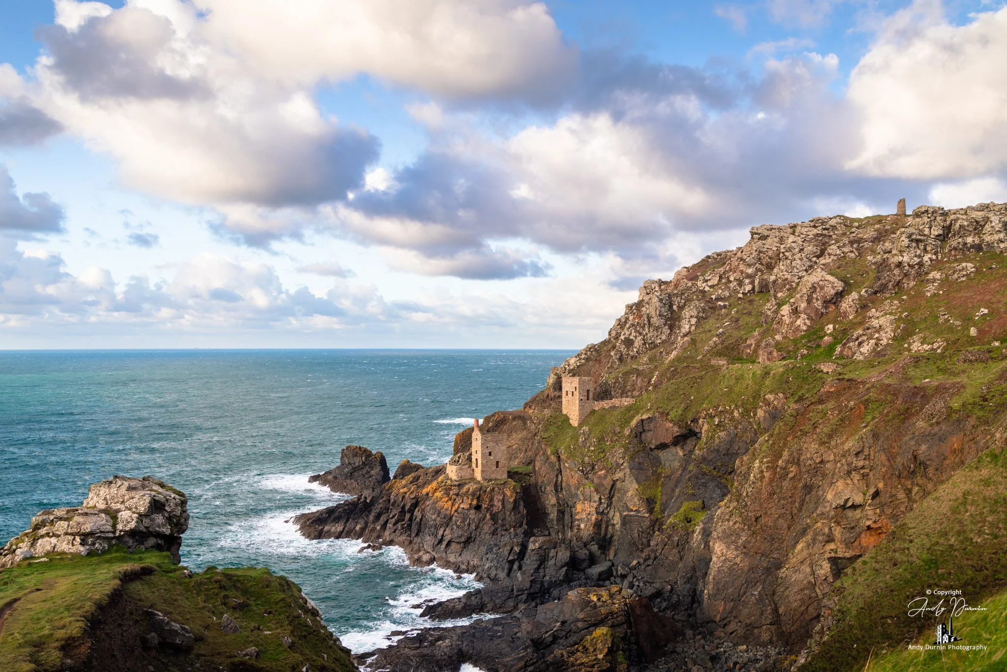 Crown Engine Houses at Botallack on rugged Cornish cliffs above the Atlantic Ocean under dramatic clouds