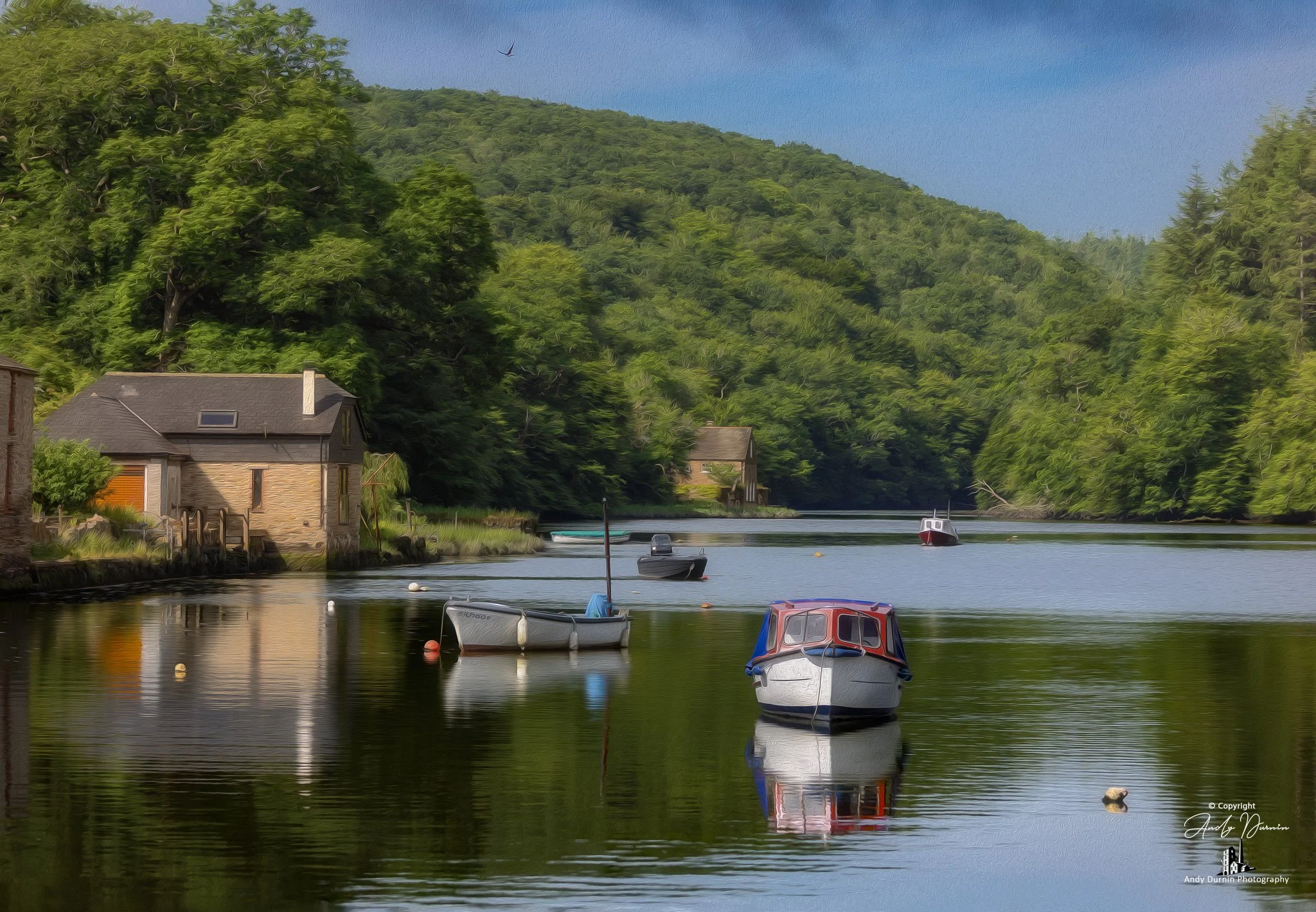 This fine art photograph of the River Lerryn at Lerryn in Cornwall captures a tranquil creekside scene with moored boats, calm reflections, riverside cottages and lush woodland. With its soft painterly feel and peaceful atmosphere, this Cornwall prin