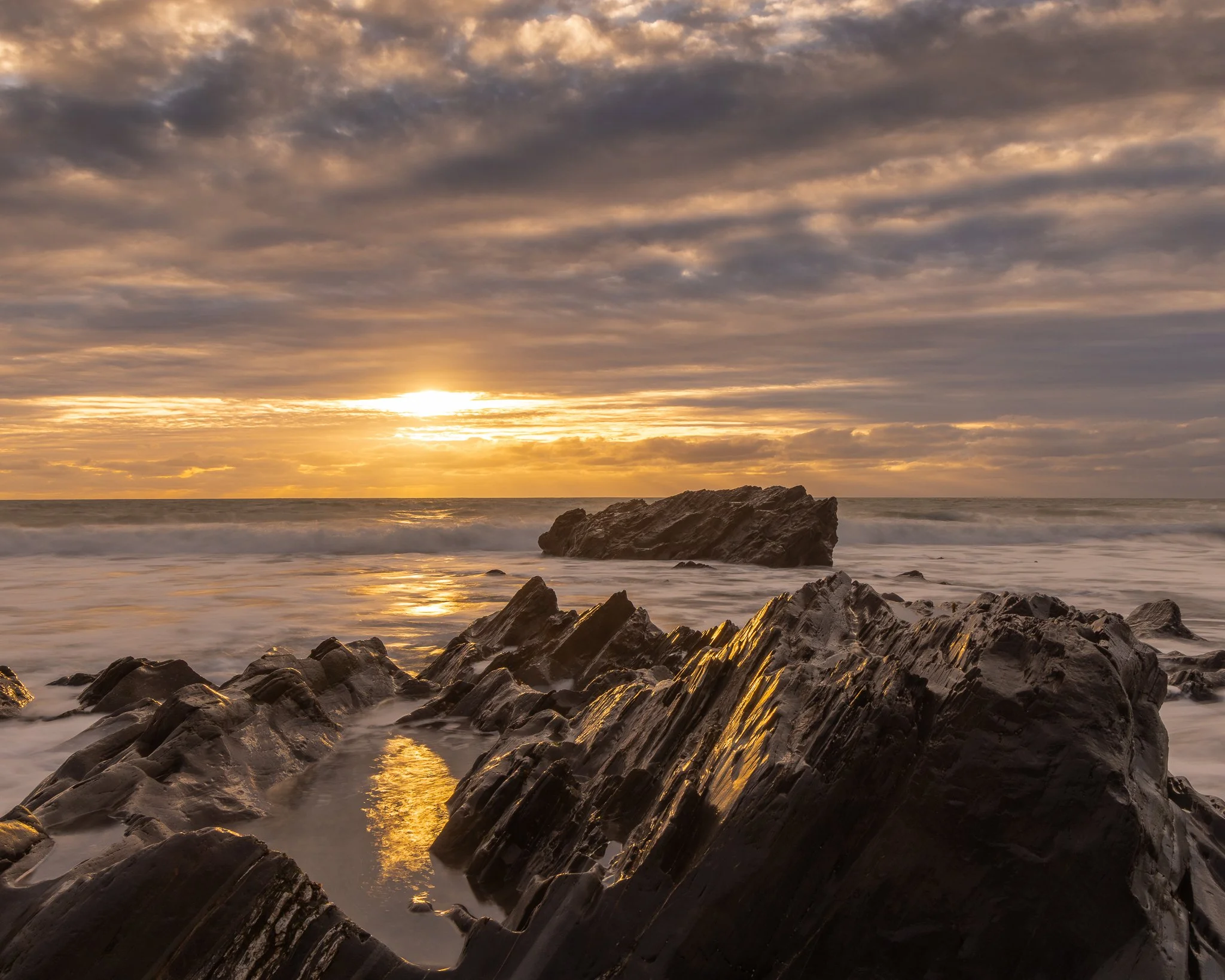 Golden sunset at Dollar Cove in Cornwall, captured as atmospheric coastal photography wall art.