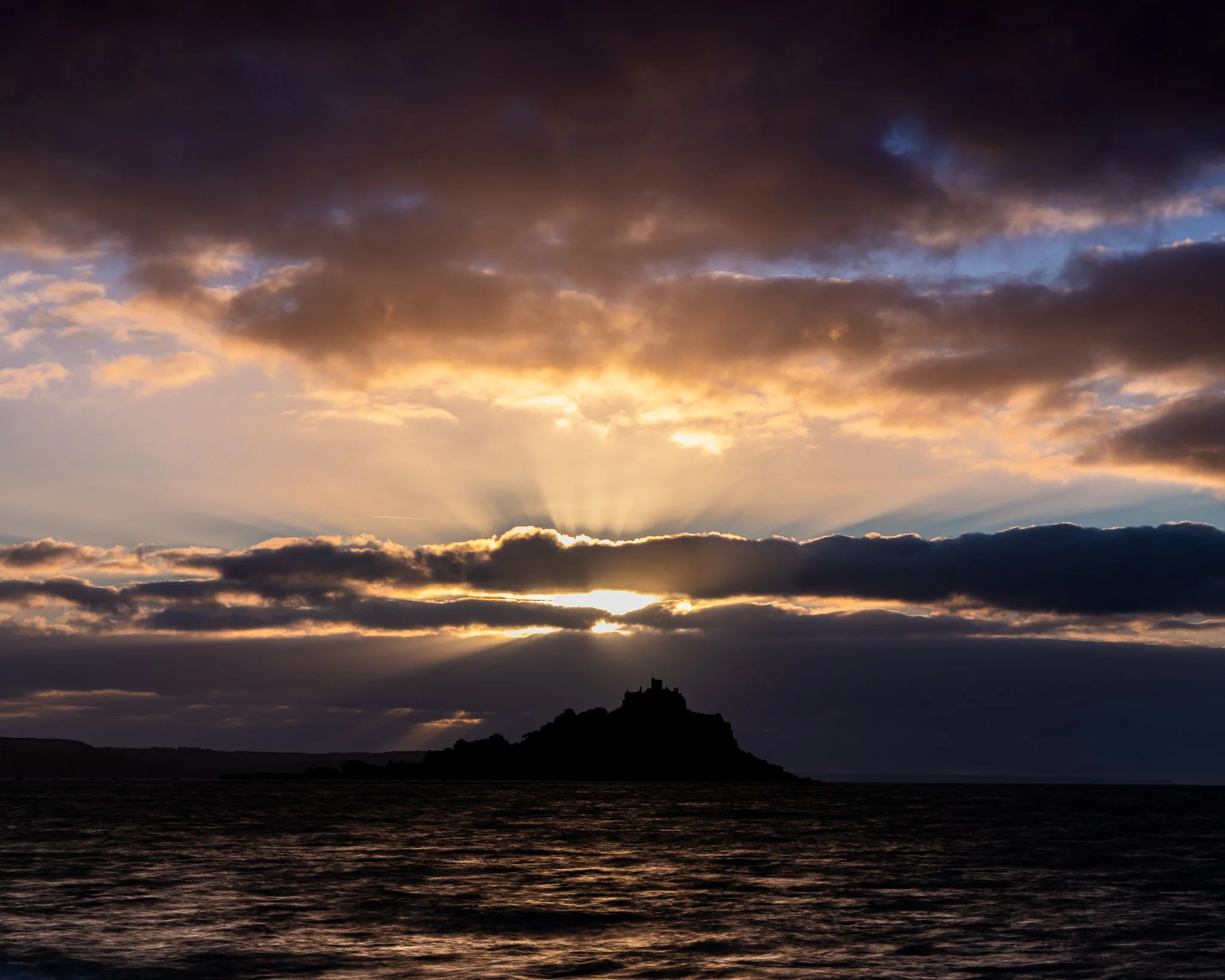 Sunrise over St Michael’s Mount in Mount’s Bay, Cornwall, with soft morning light across the sea.