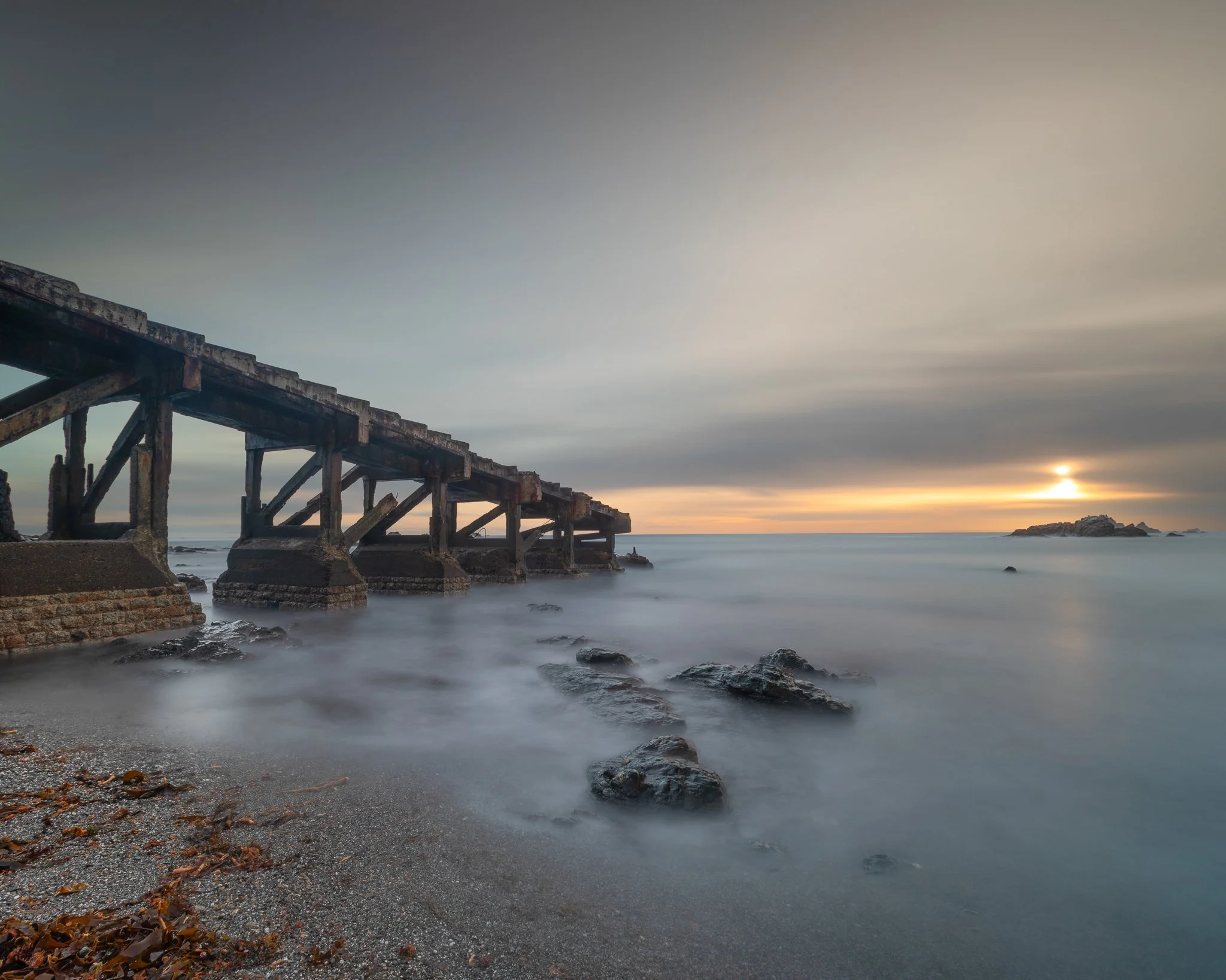 Sunset at Polpeor Cove with the old Lizard lifeboat launch on The Lizard Peninsula, Cornwall.
