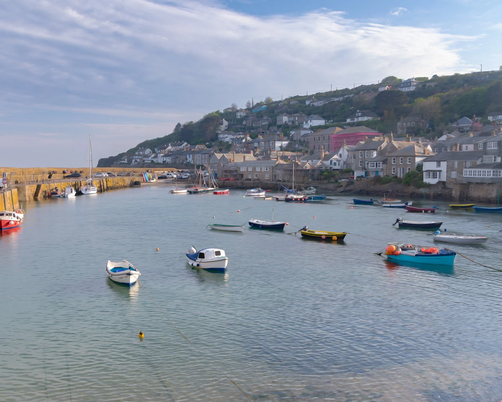 Mousehole Harbour in West Cornwall, with fishing boats and traditional harbour buildings captured in soft Cornish light.