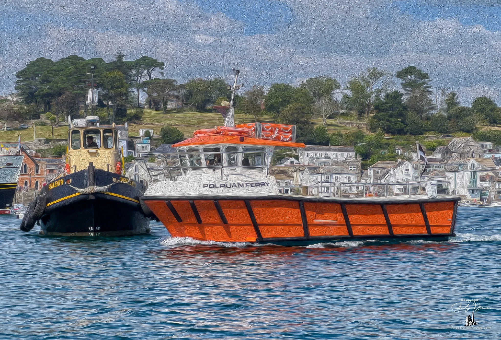 Penleath and the Polruan Ferry.  Two boats on the water, one black and yellow, the other orange and white, with a hillside town and trees in the background.