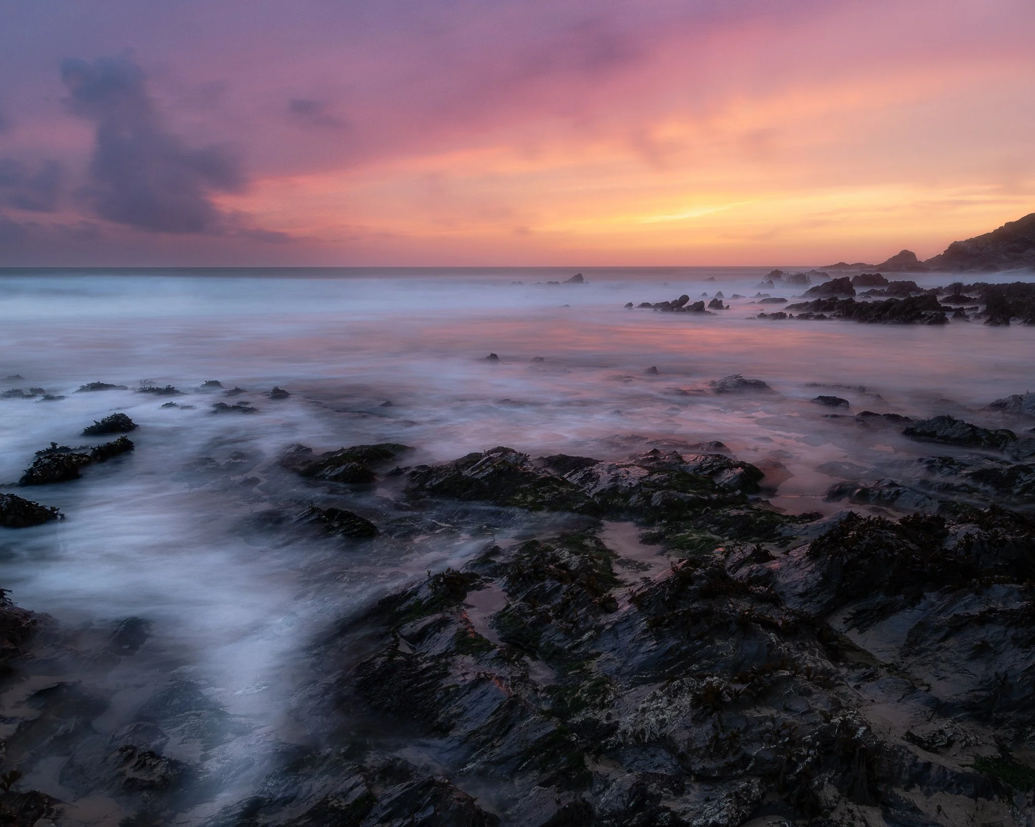 Sunset over Dollar Cove on The Lizard Peninsula, with warm evening light across the Cornish coast.