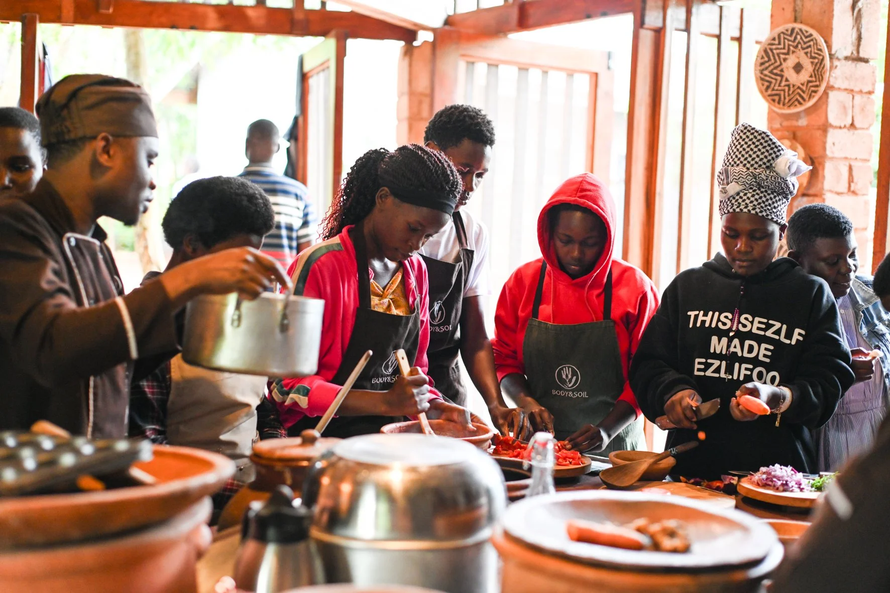 Students at the RUCID organic college cooking in the BODY&SOIL energy saving kitchen.