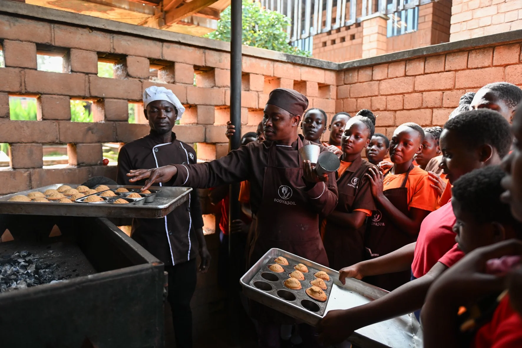 Body and soil chefs teach school kids how to bake using a local oven.