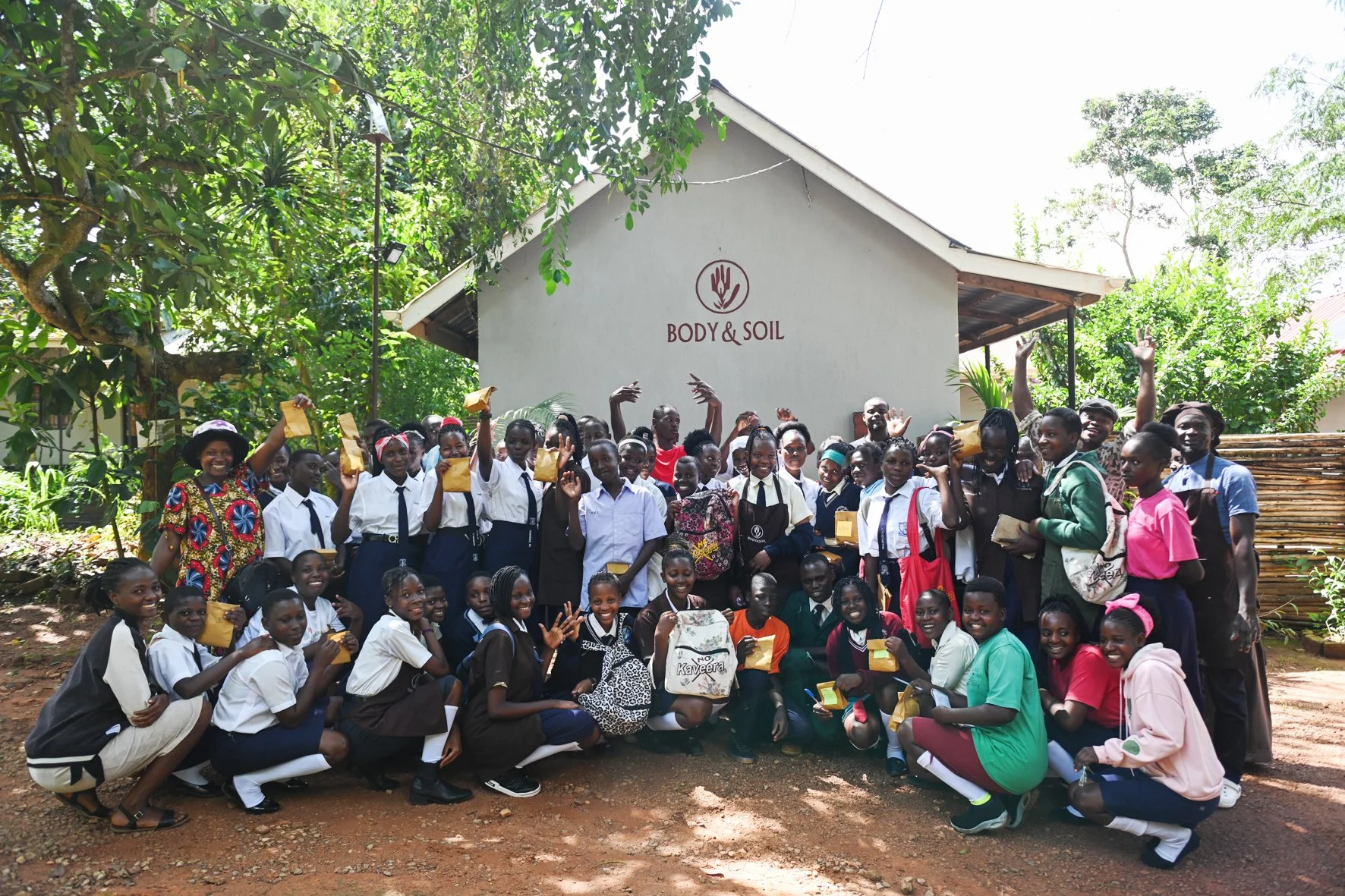 School kids from body and soil clubs jumping up in a group photo