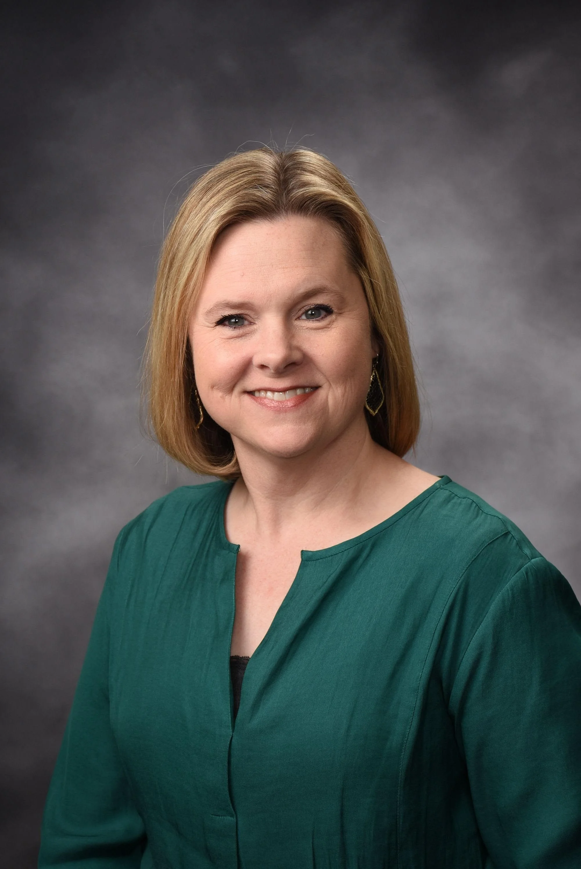 Brandy Edwards - Reading Specialist - Woman with Blonde Hair, Smiling, Wearing Green Shirt