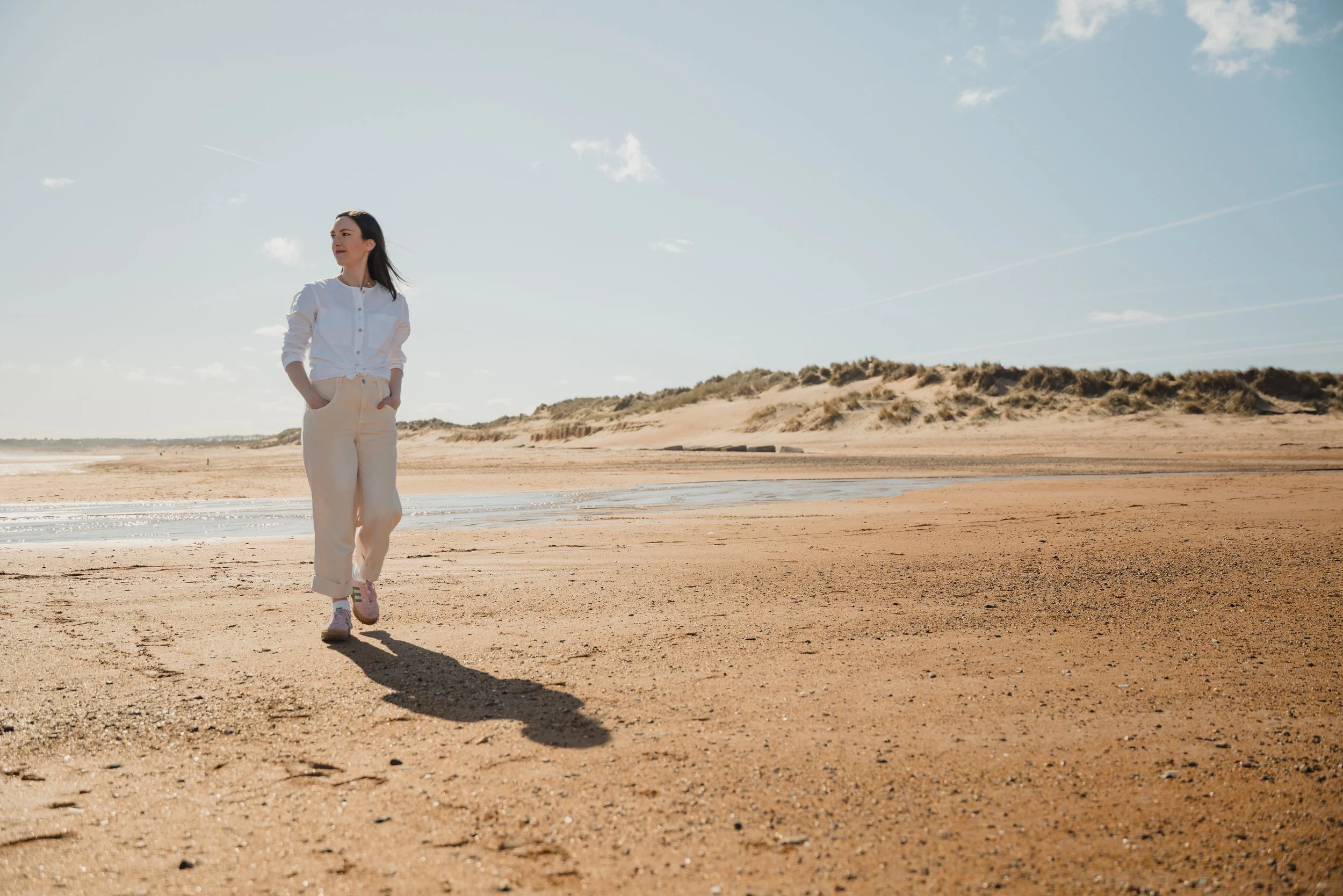 A woman walking along a beach