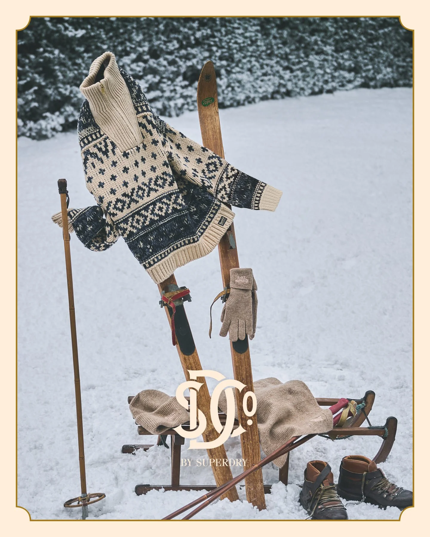 Superdry Christmas campaign on a slope with skis, showshoes and a thick winter jumper