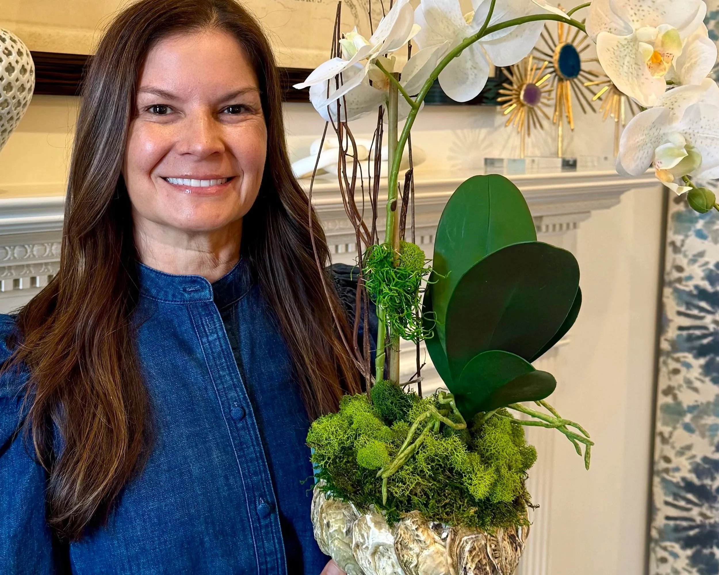 Kristi Glidewell and one of her custom faux orchid arrangements in Charlotte NC