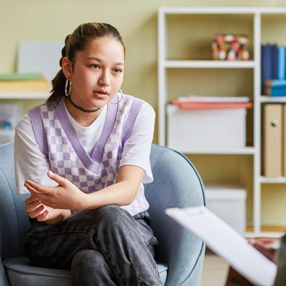 Teen talking with therapist during mental health treatment session in Menlo Park