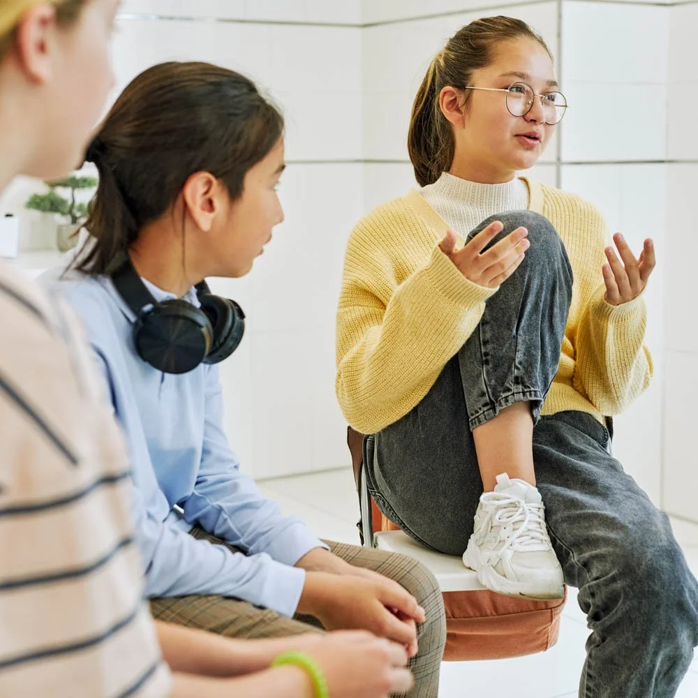 Teens engaged in a supportive outpatient group therapy session focused on communication, coping skills, and emotional growth.