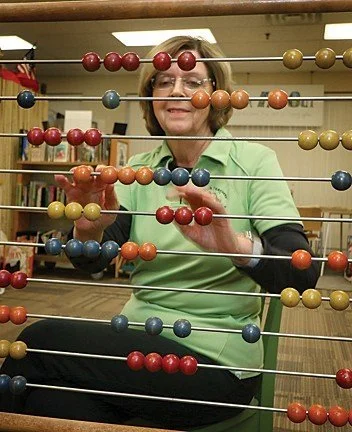 Sue Playing with Child's Abacas
