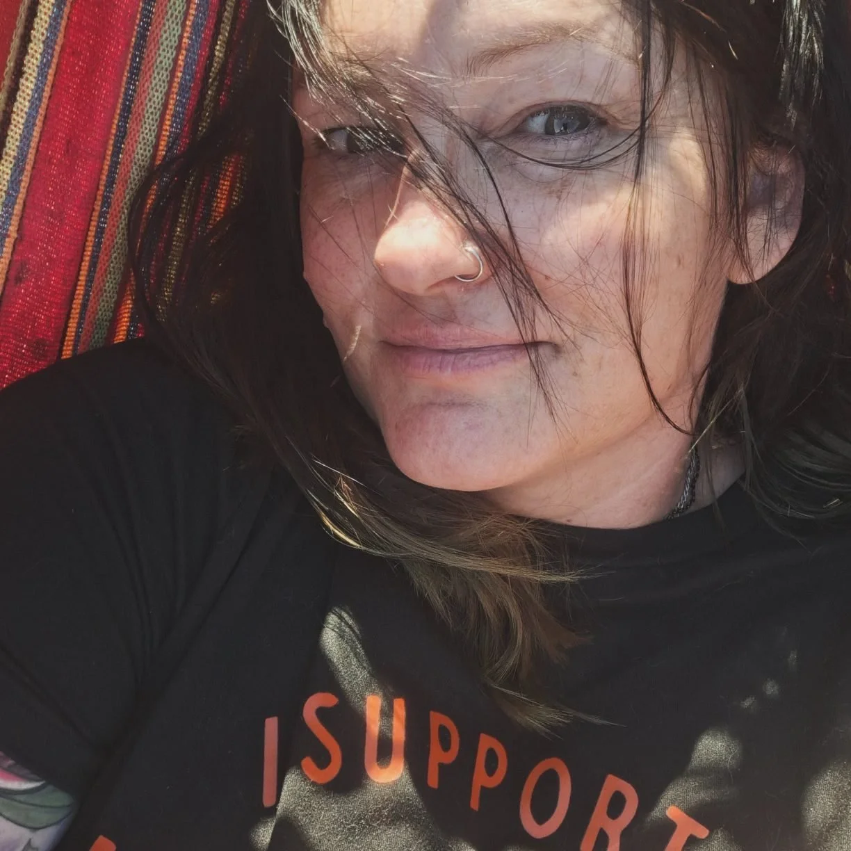 DaNae Sweet close up of her face as she is laying in her hammock with no makeup.