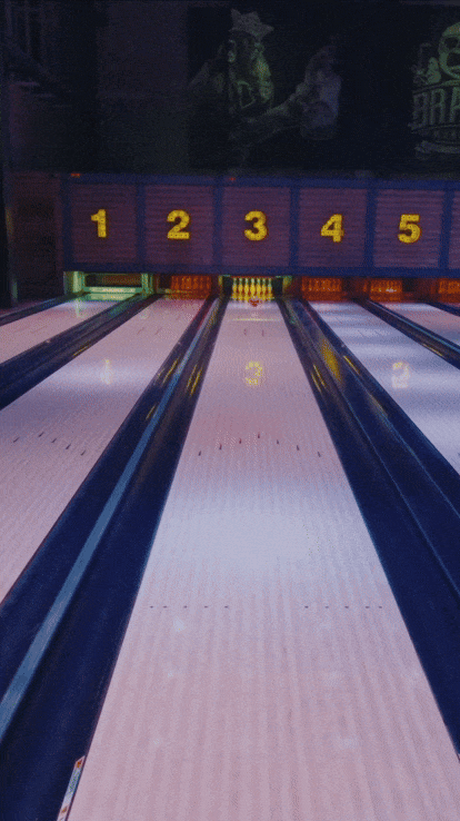 A bowling alley with five lanes numbered 1 through 5, showing the pins arranged at the end of lane 3.