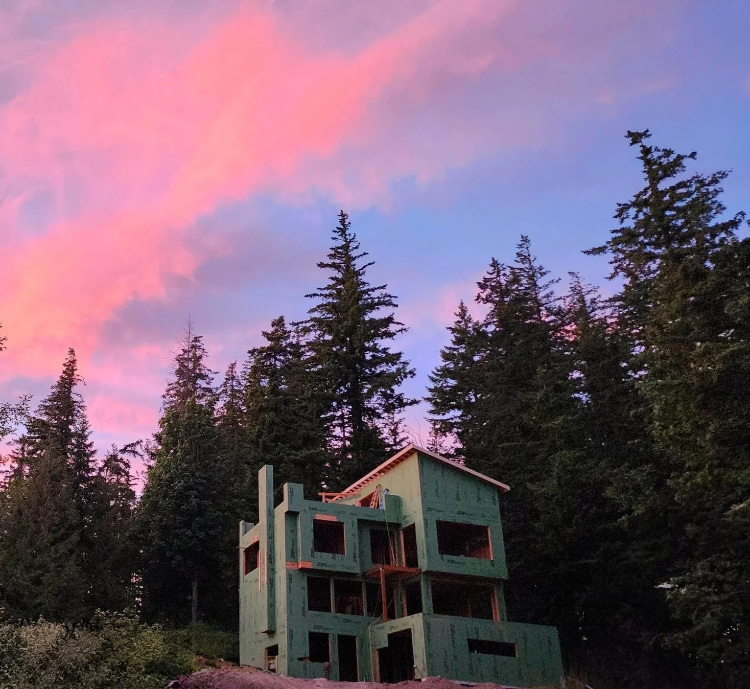 New big house partially framed with zip sheathing at sunset