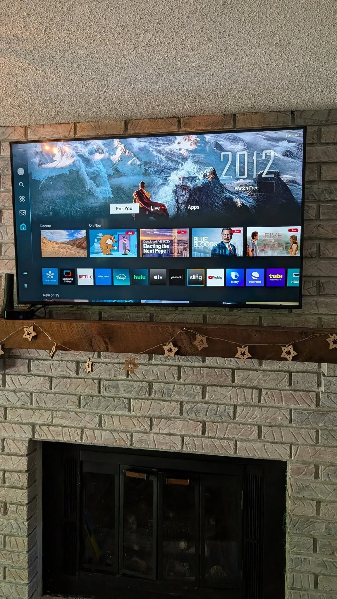 TV mounted above the fireplace
