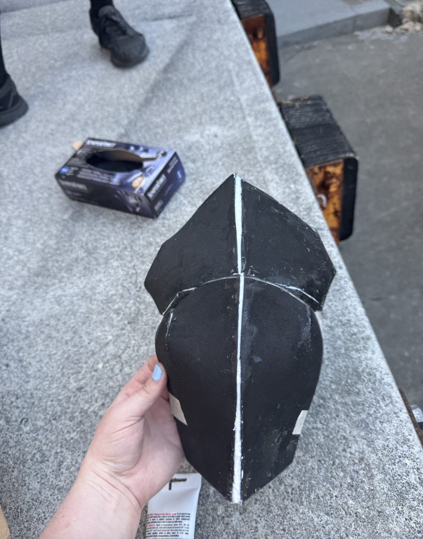 Caulking the gaps on the shoulder plate for stability, side view.