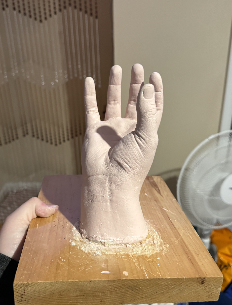 Hand super glued to a wooden base with the first coat of paint.