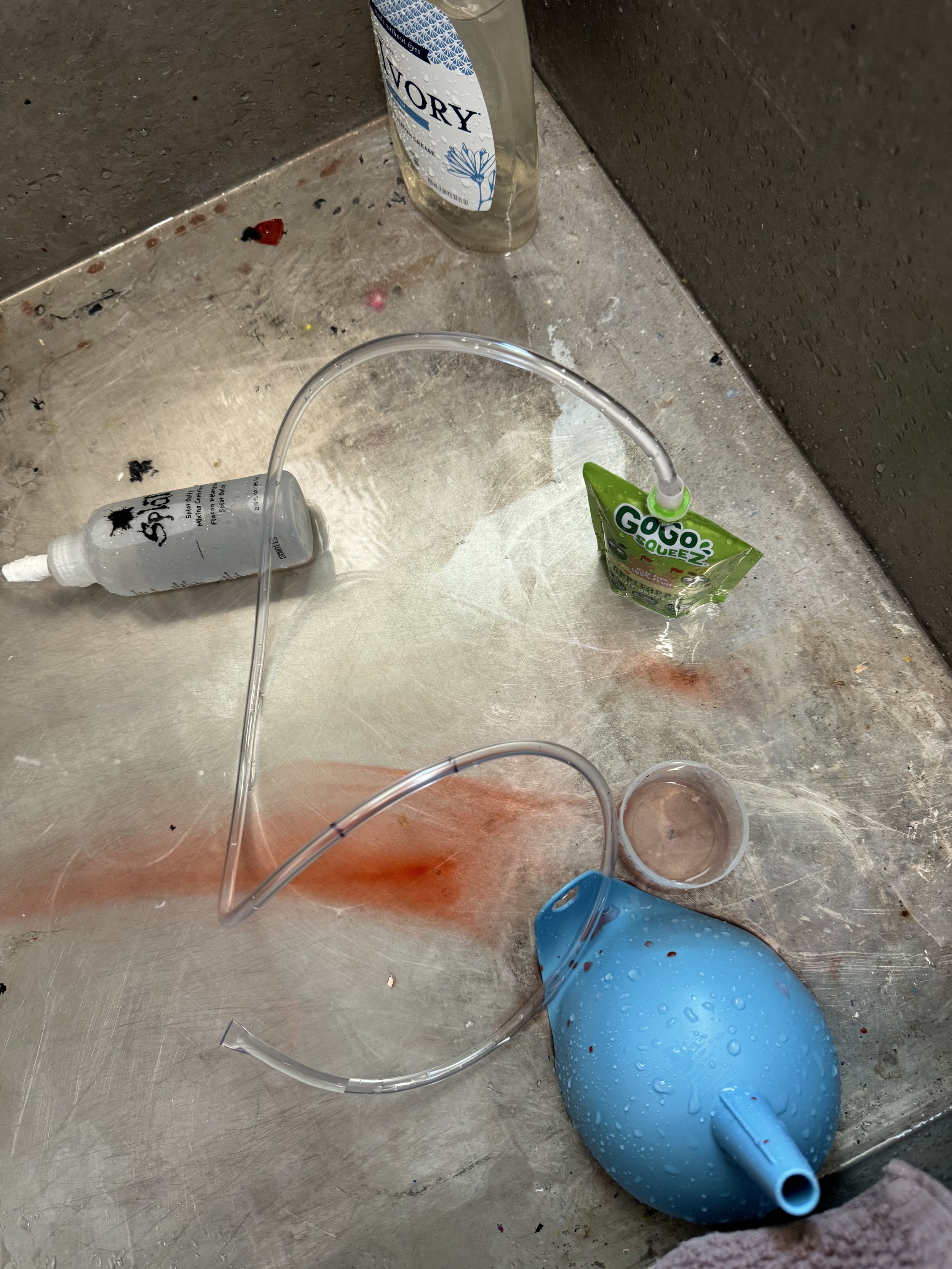 Attempt #2 to seal the tubing with a cleaned Gogo squeeze pouch.