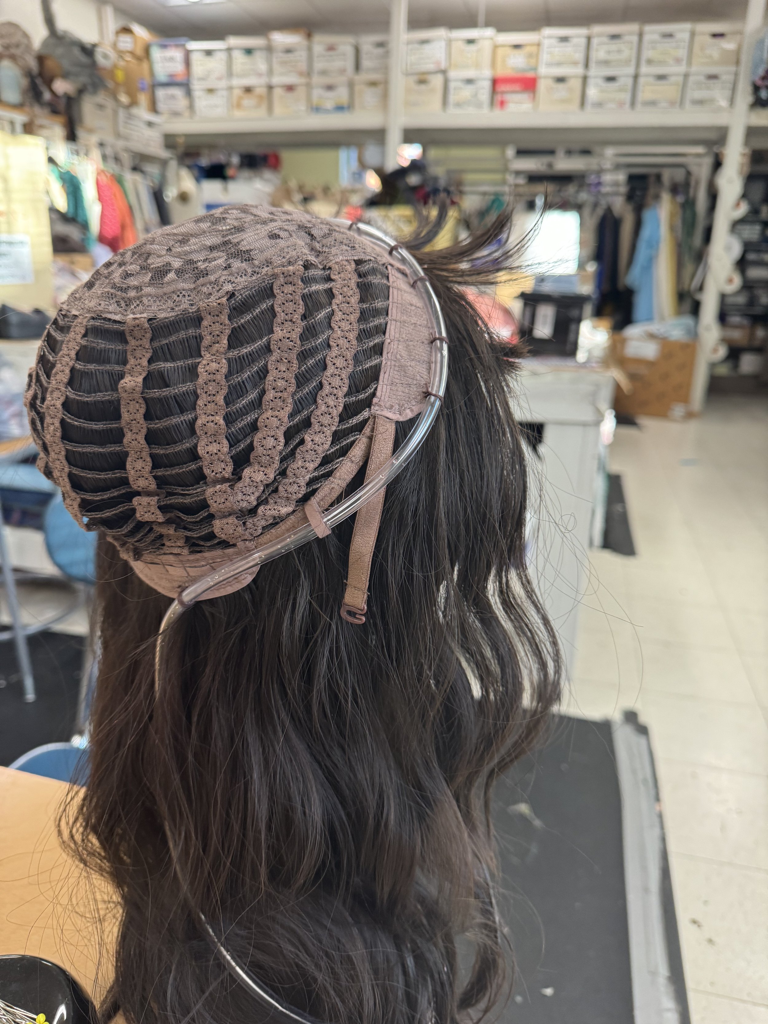 The wig secured by tacking, back view.