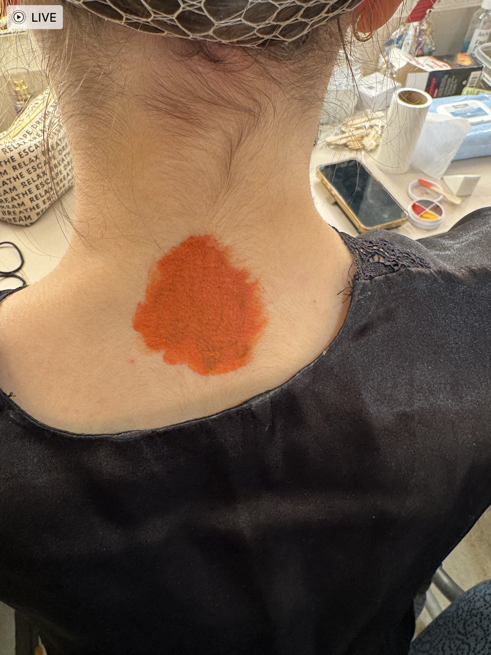 Layer of orange color corrector to cancel out the blue in the ink, then powdered.