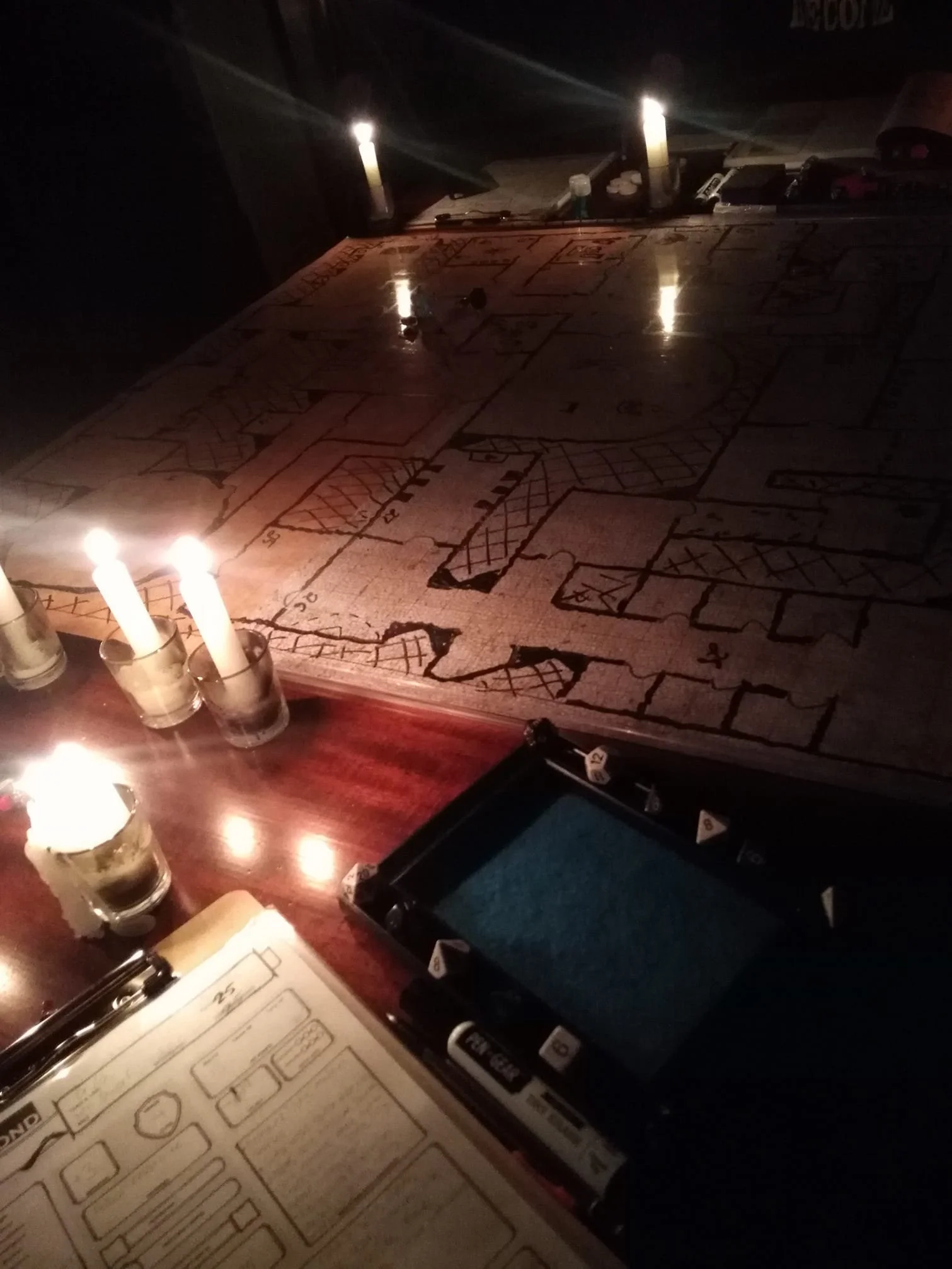 A candlelit Dungeons and Dragons (D&D) tabletop game board, representing nerd-friendly and geek-affirming therapy interests in Kansas.