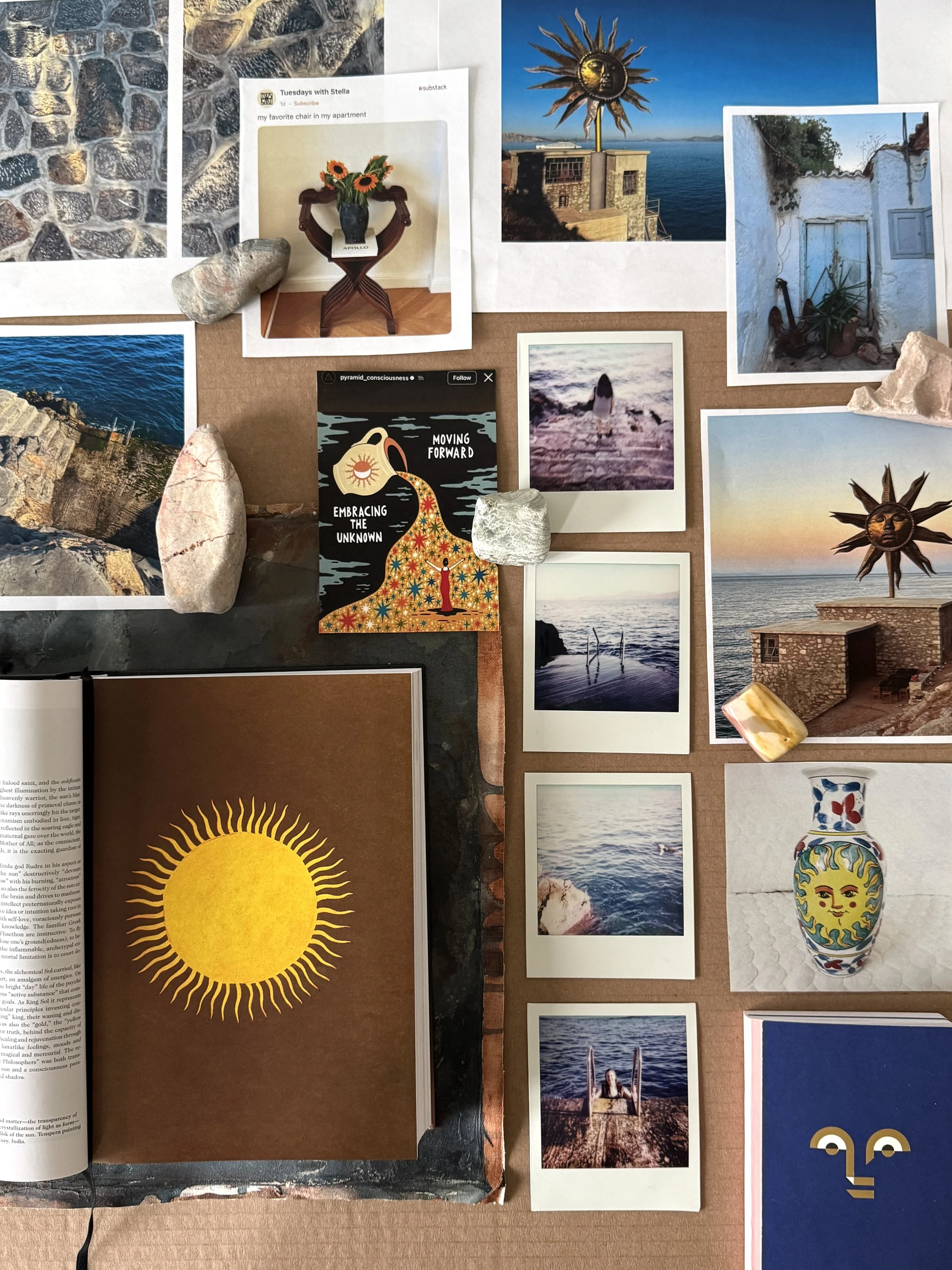 Artist excavation table with Polaroid photographs, stones, books, symbolic imagery, and visual references from Hydra and Greece.