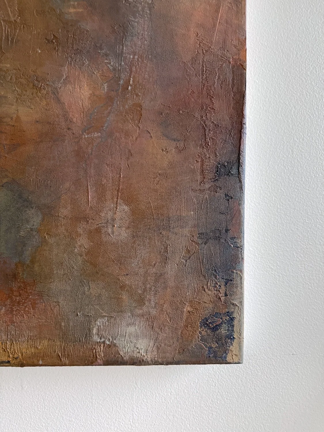 Corner detail of What Remains showing layered paint, textured surface, and color variation