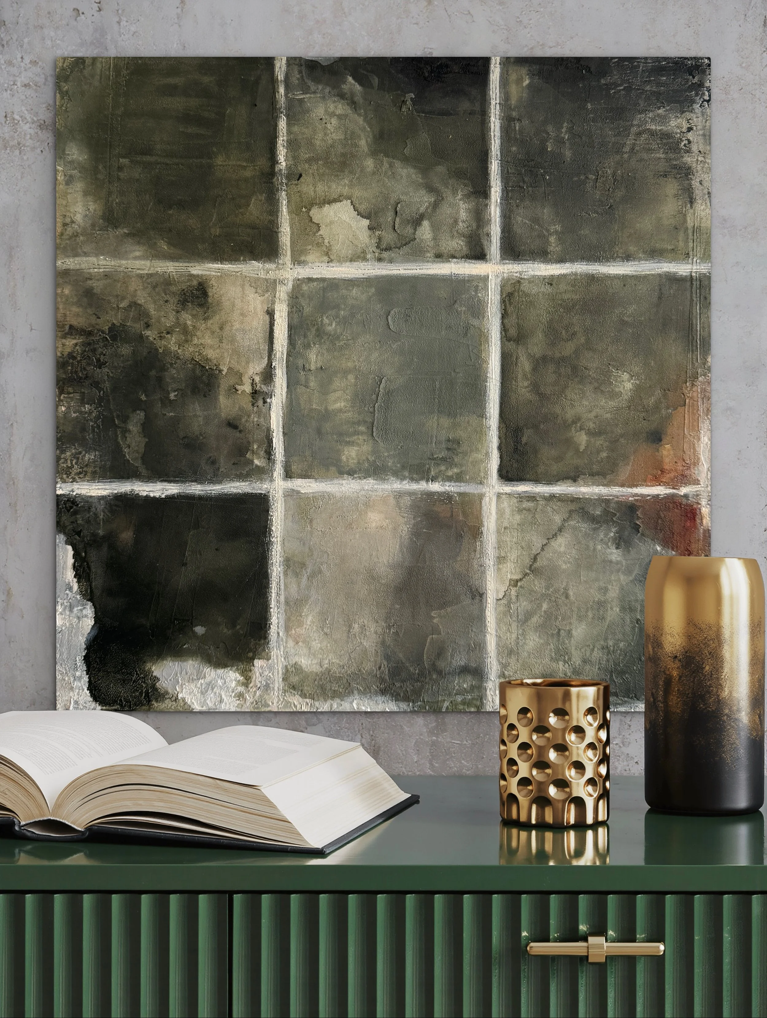 Inhabiting Time No. 1 styled above a dark green console with an open book and sculptural decorative objects.
