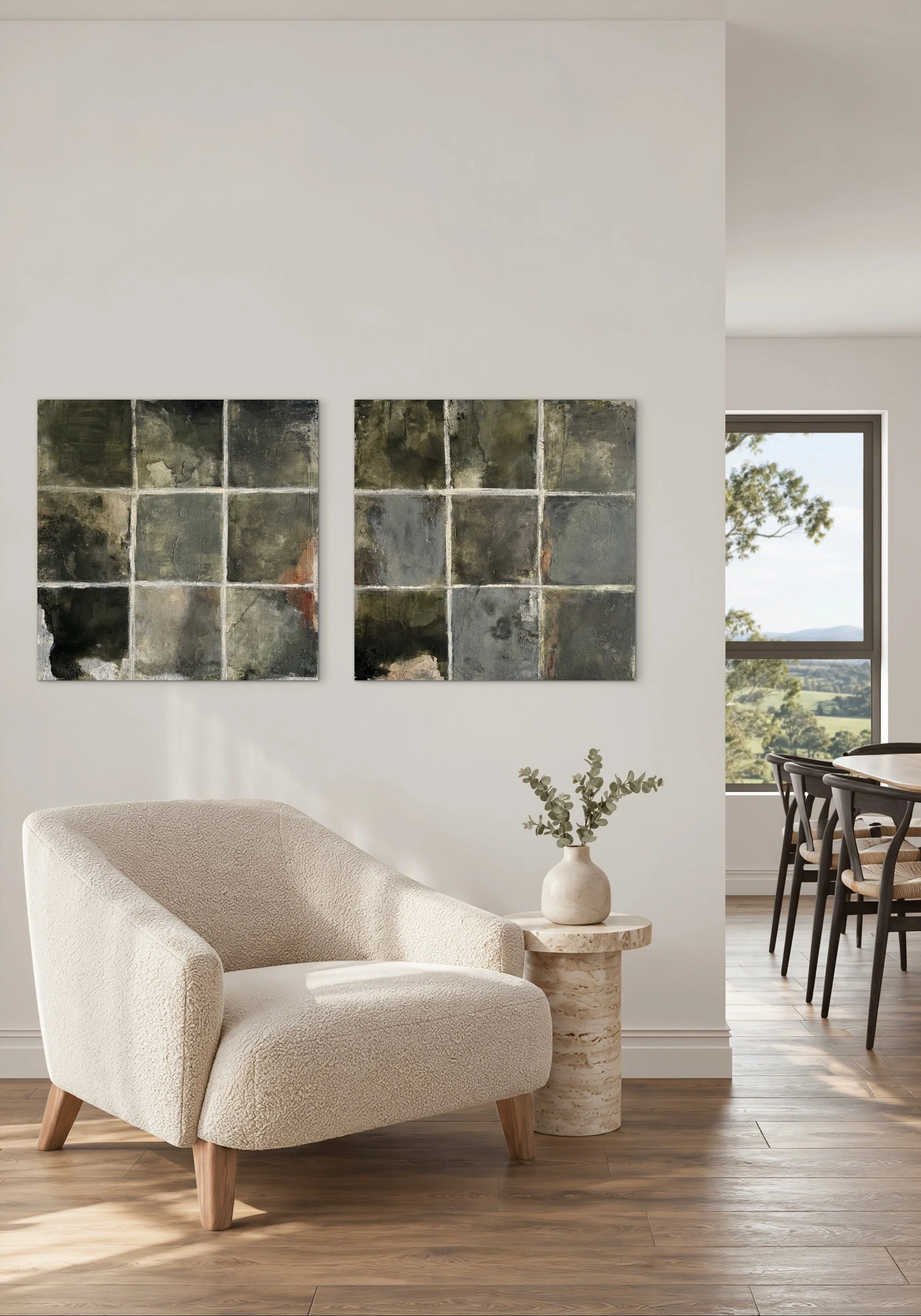 Inhabiting Time No. 1 and No. 2 displayed as a diptych above a cream chair in a light-filled neutral interior.