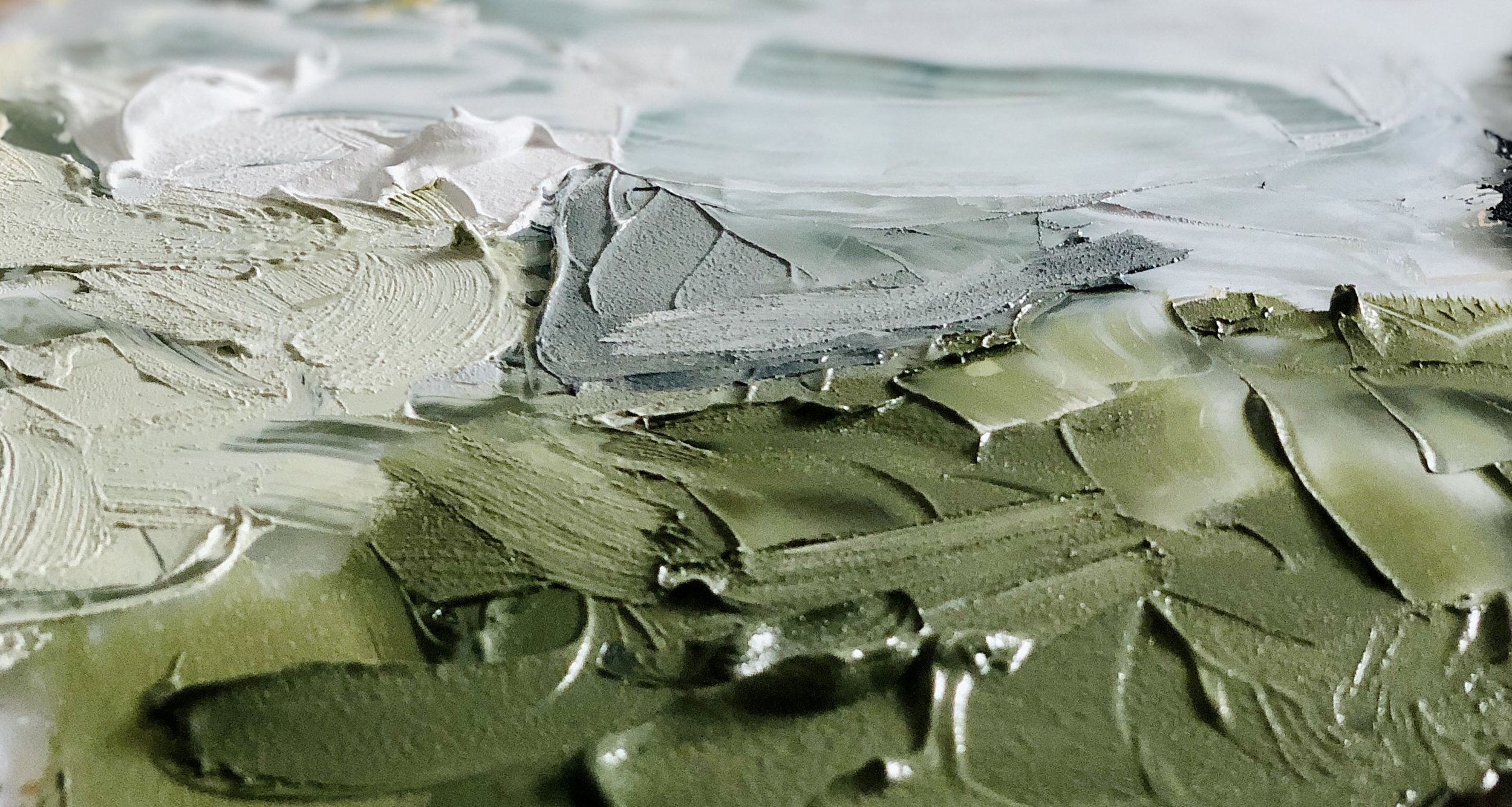 Close-up of an artist’s paint palette showing layered, textured paint used in the studio process of Melanie Biehle.