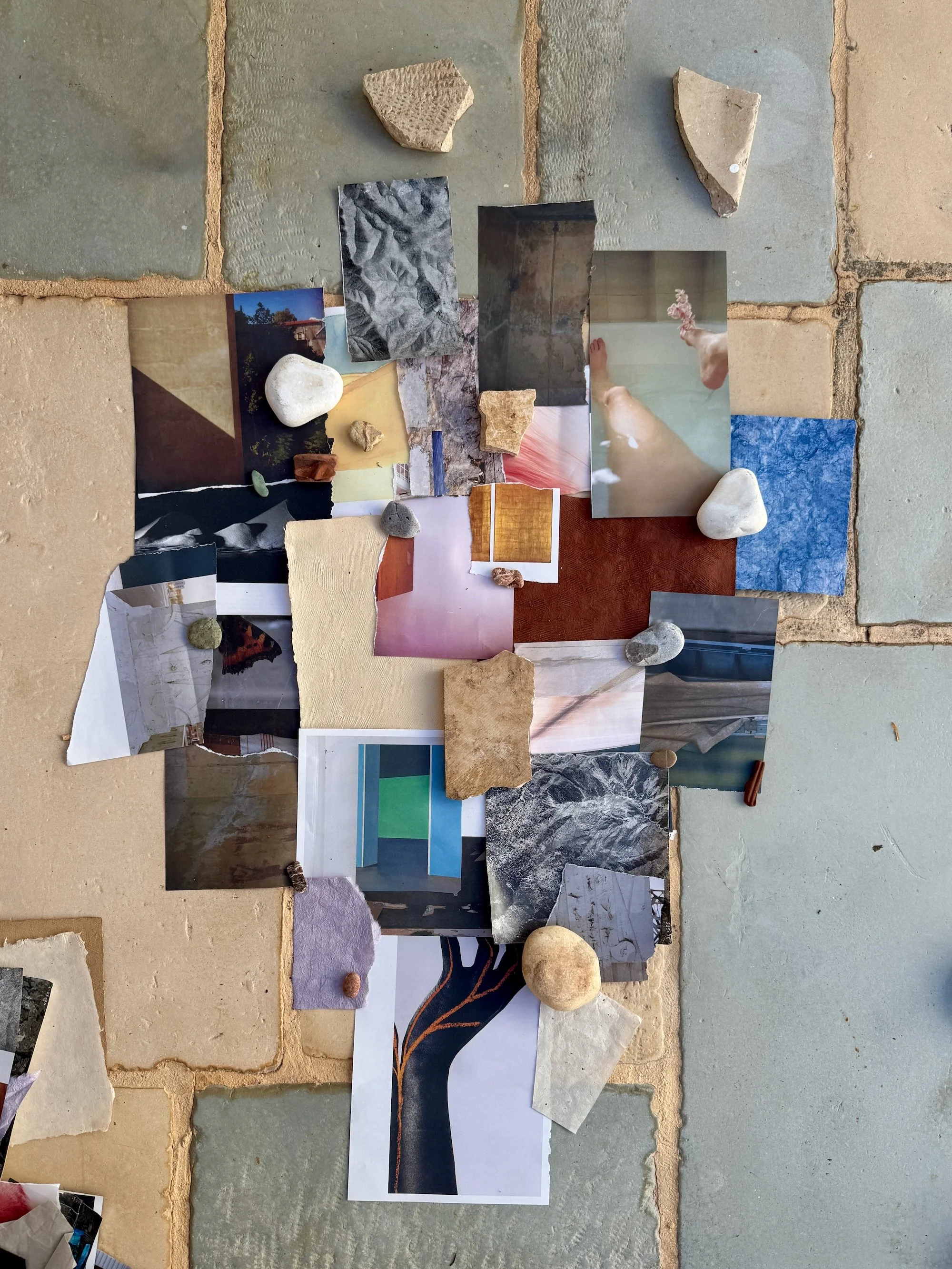 Experimental paper collage arranged with found stones on a tiled courtyard floor in Hydra, Greece.